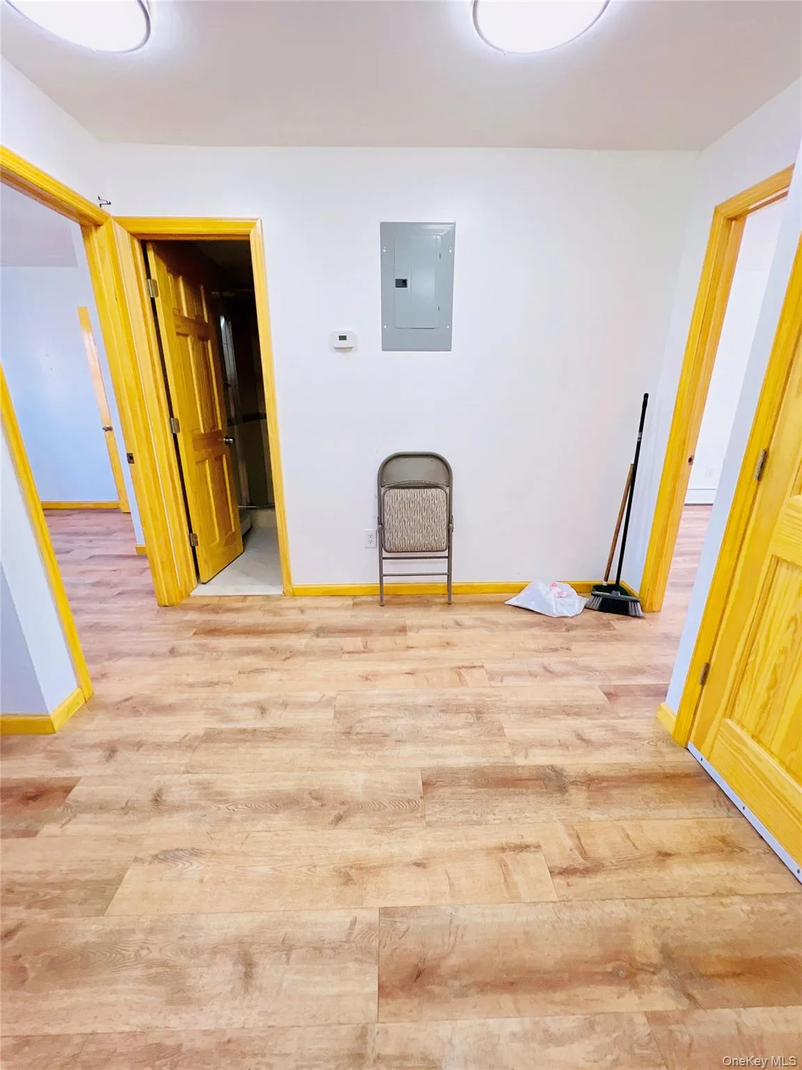 Spare room with light wood finished floors and electric panel Spare room with light wood finished floors and electric panel