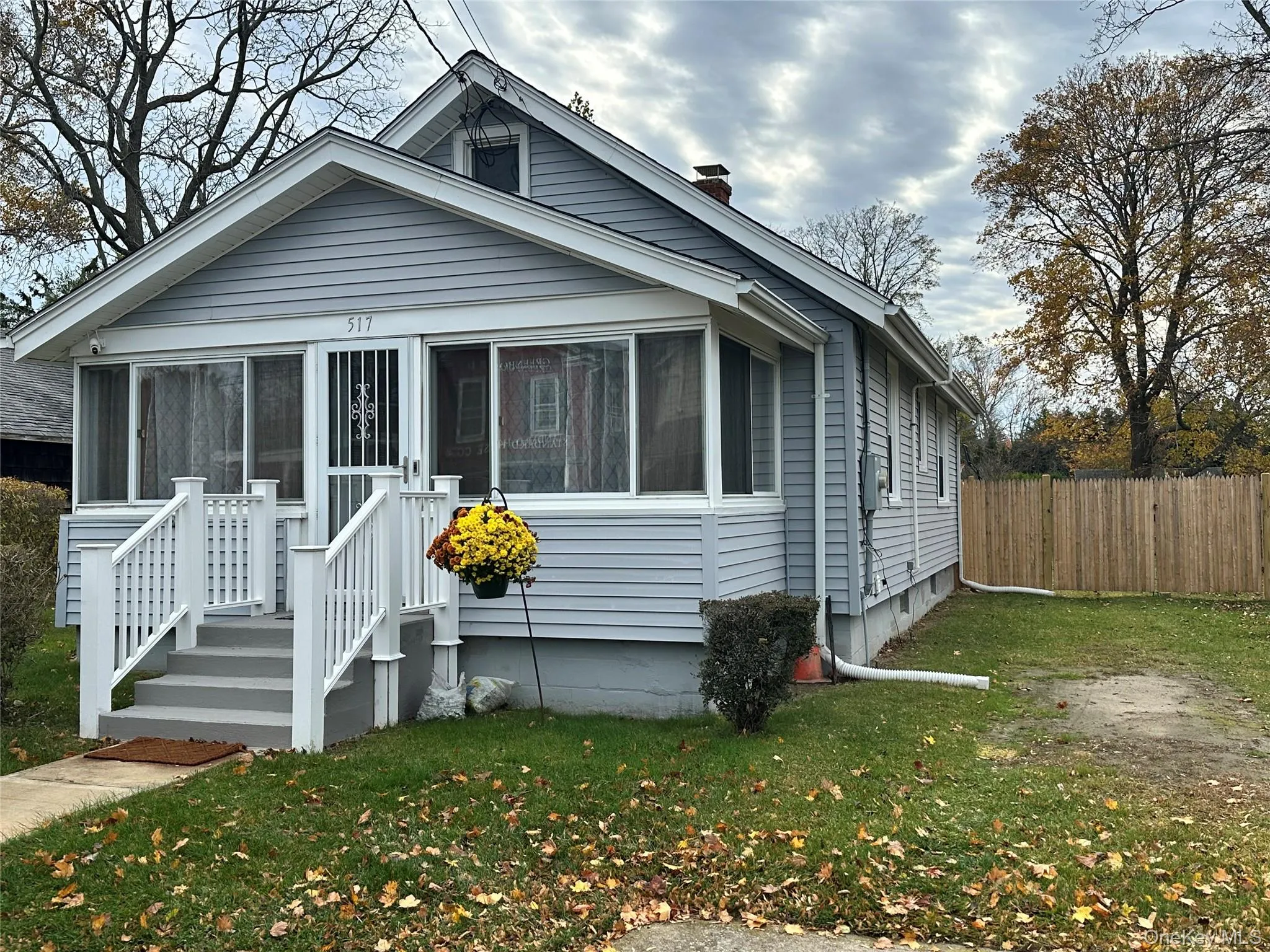 Bungalow-style house with a sunroom and a chimney Bungalow-style house with a sunroom and a chimney