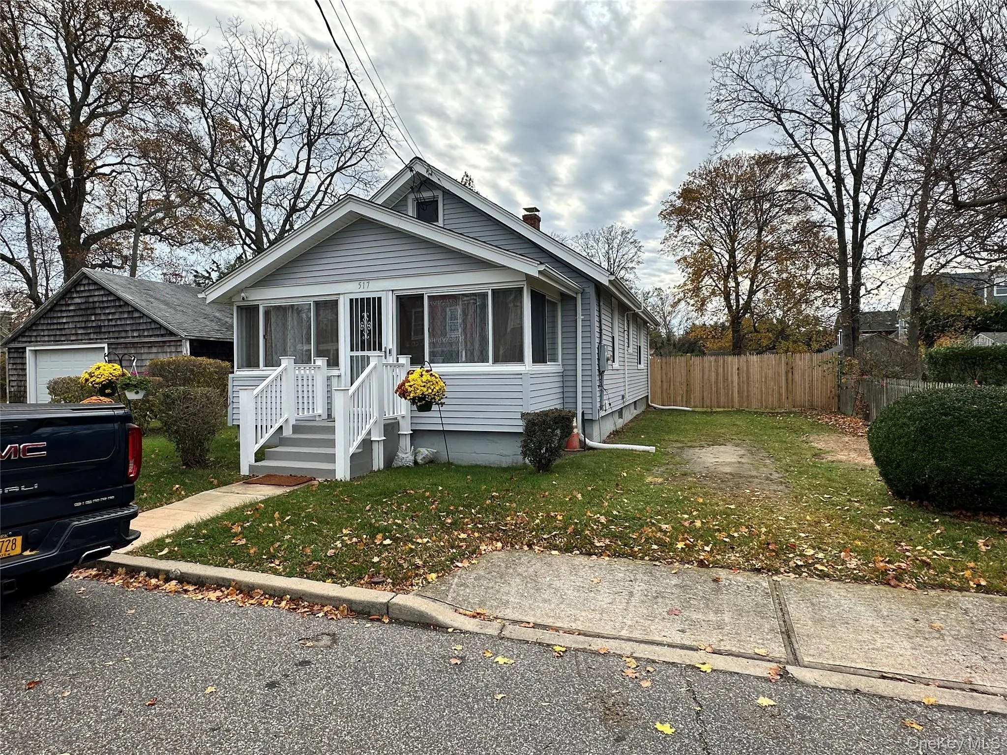 Bungalow-style home with a sunroom and a chimney Bungalow-style home with a sunroom and a chimney