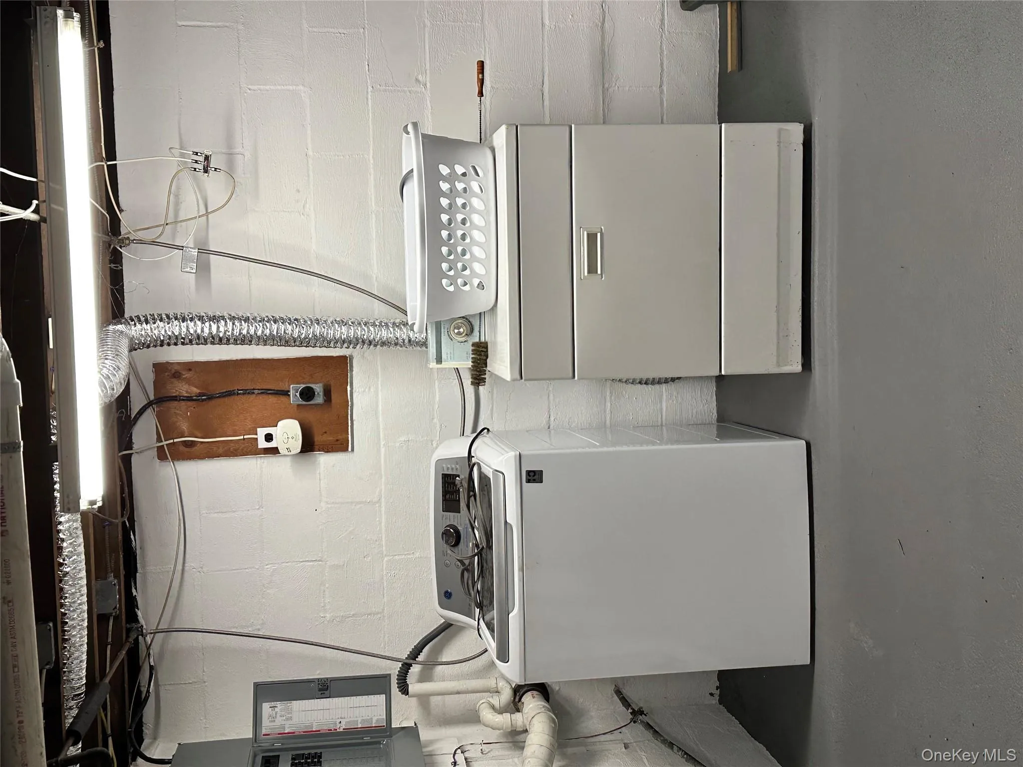 Laundry area with washing machine and clothes dryer and finished concrete flooring Laundry area with washing machine and clothes dryer and finished concrete flooring