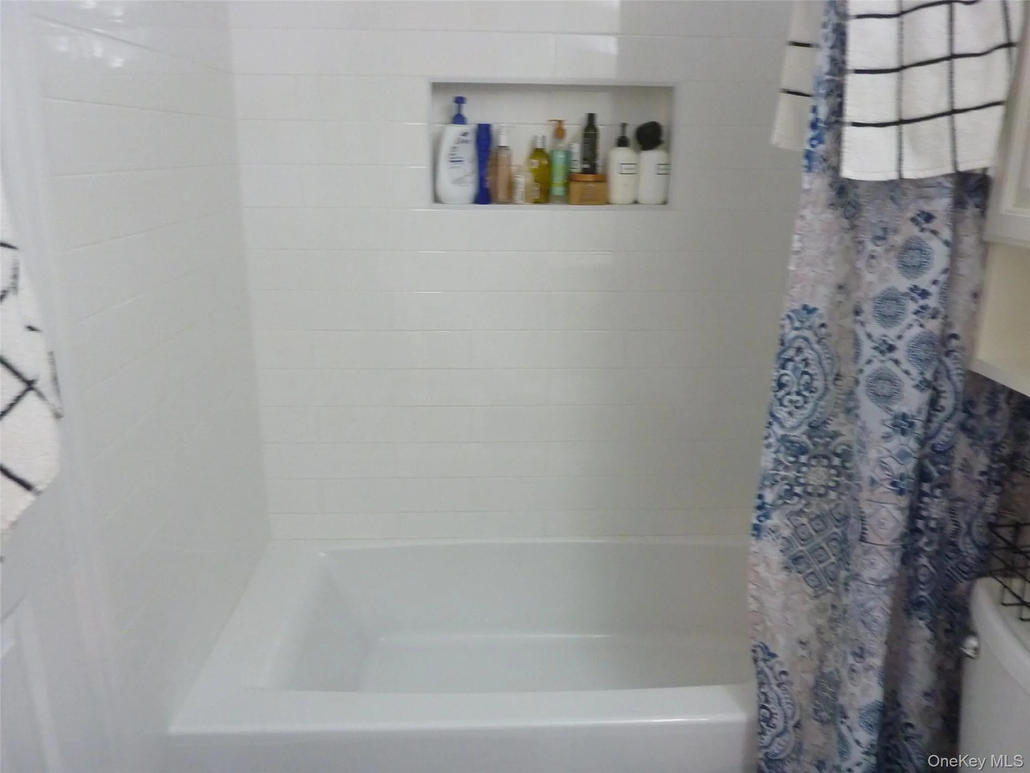 Bathroom featuring shower / bathtub combination with curtain Bathroom featuring shower / bathtub combination with curtain