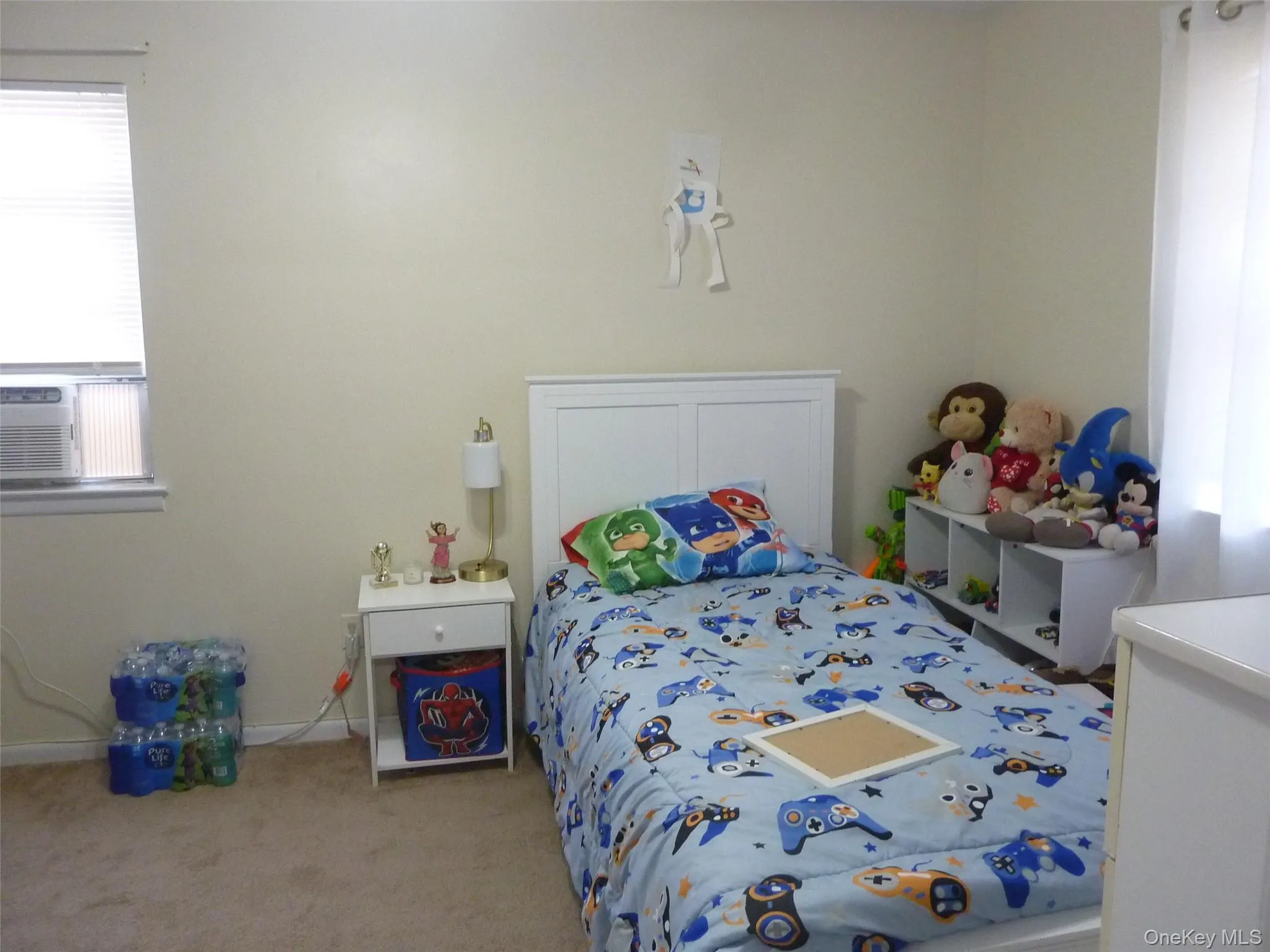 Bedroom featuring light carpet and cooling unit Bedroom featuring light carpet and cooling unit