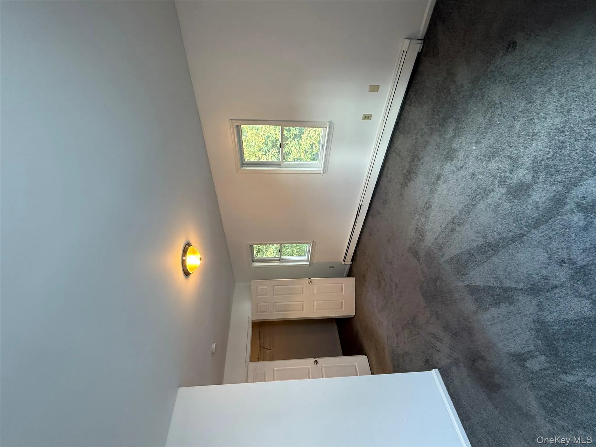 Unfurnished room with baseboard heating and dark carpet Unfurnished room with baseboard heating and dark carpet