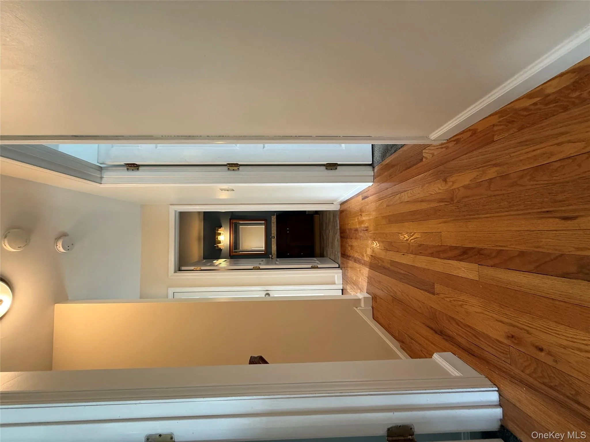 Corridor with light wood-style flooring and baseboards Corridor with light wood-style flooring and baseboards