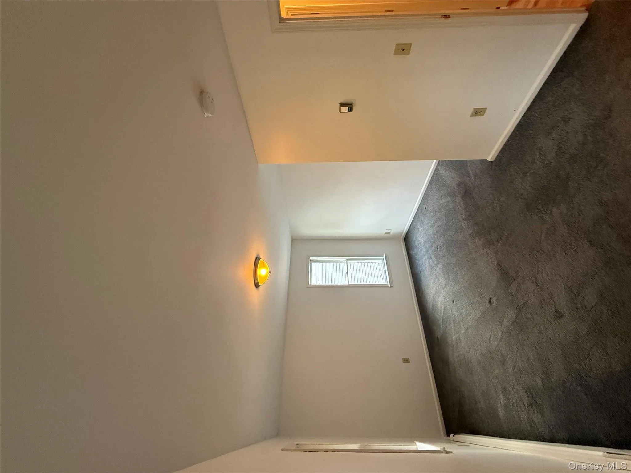 Empty room featuring dark carpet and baseboards Empty room featuring dark carpet and baseboards