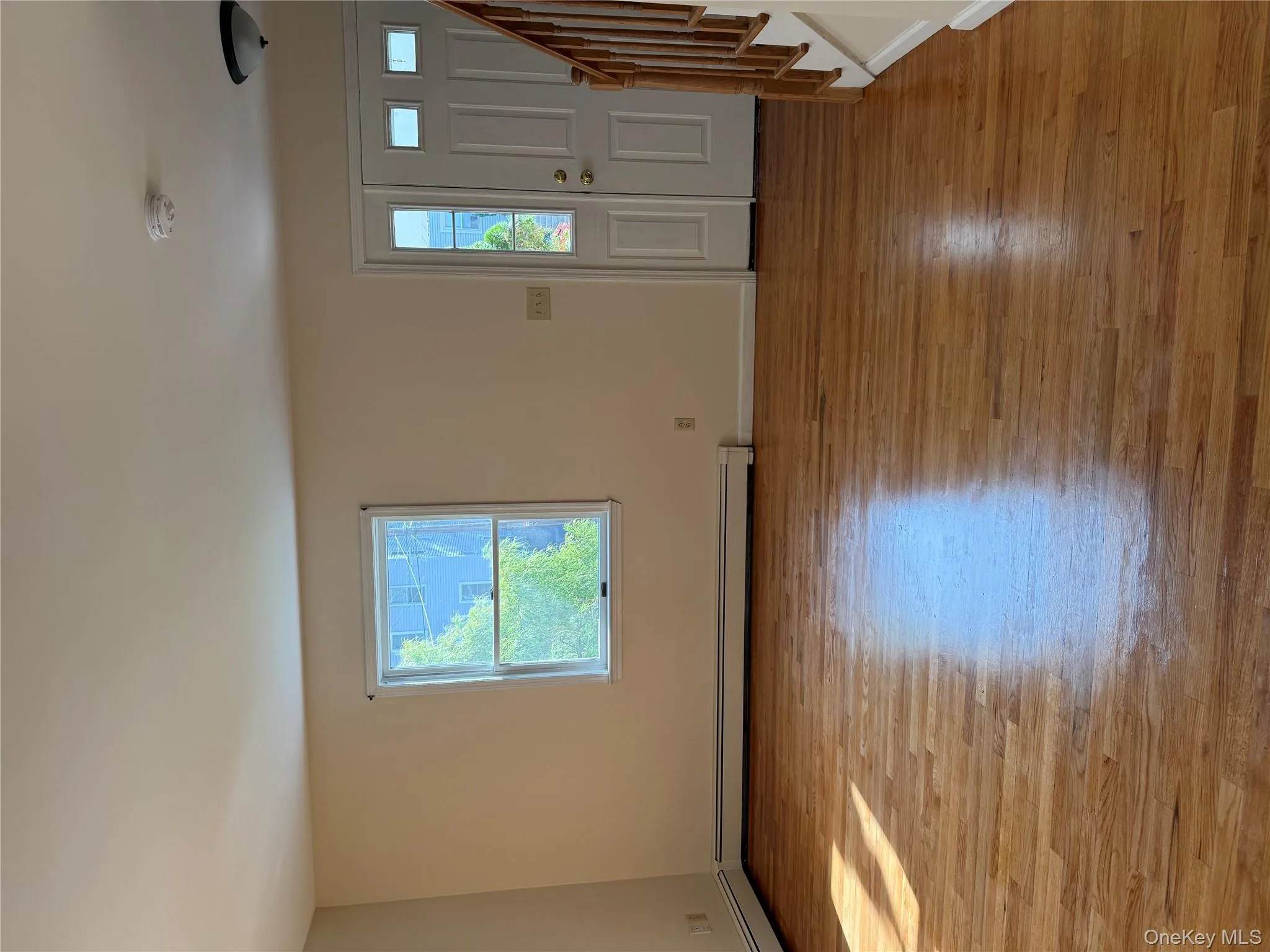 Entryway with stairway, plenty of natural light, and light wood-style floors Entryway with stairway, plenty of natural light, and light wood-style floors