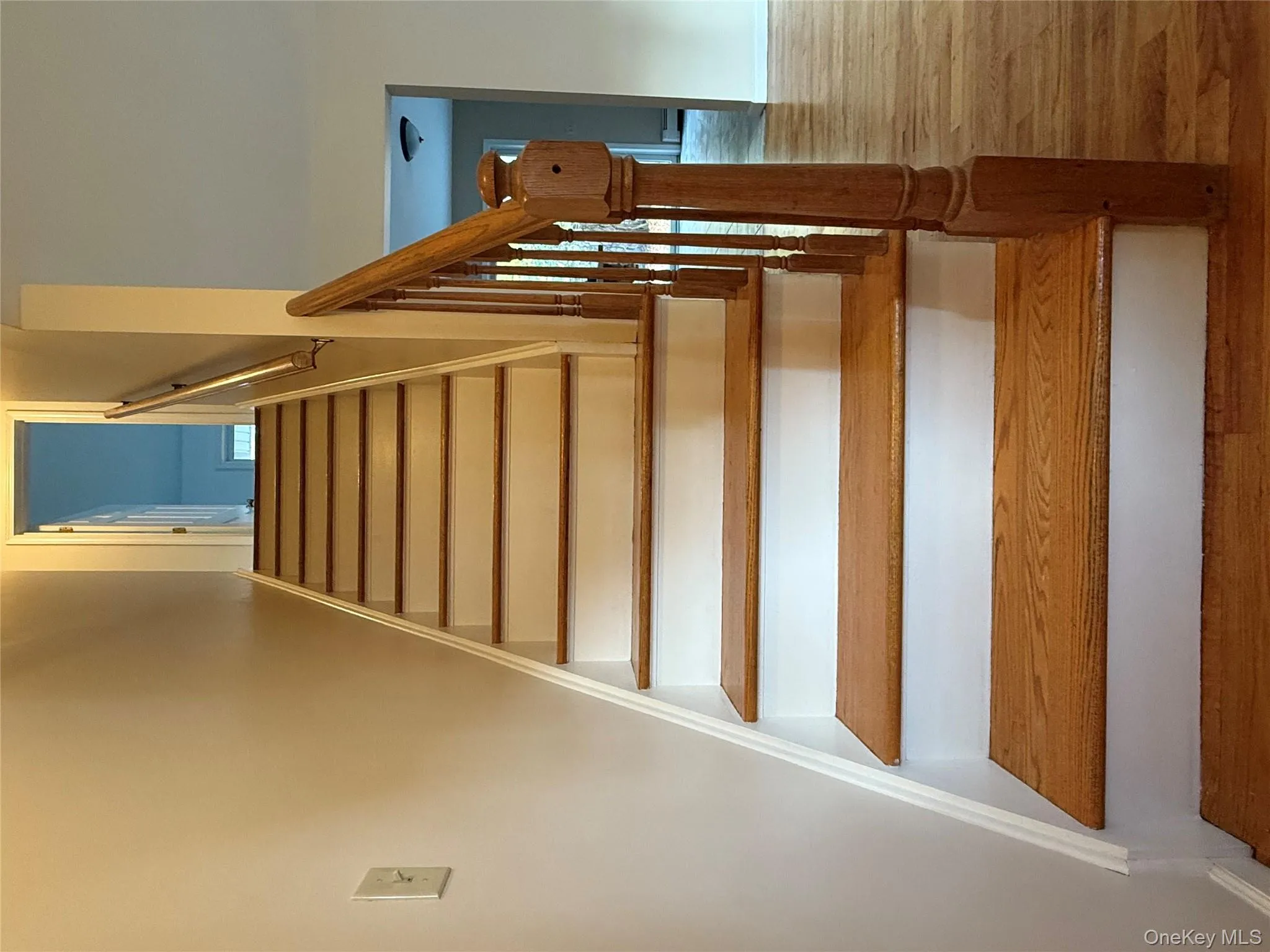 Stairs featuring wood finished floors and baseboards Stairs featuring wood finished floors and baseboards