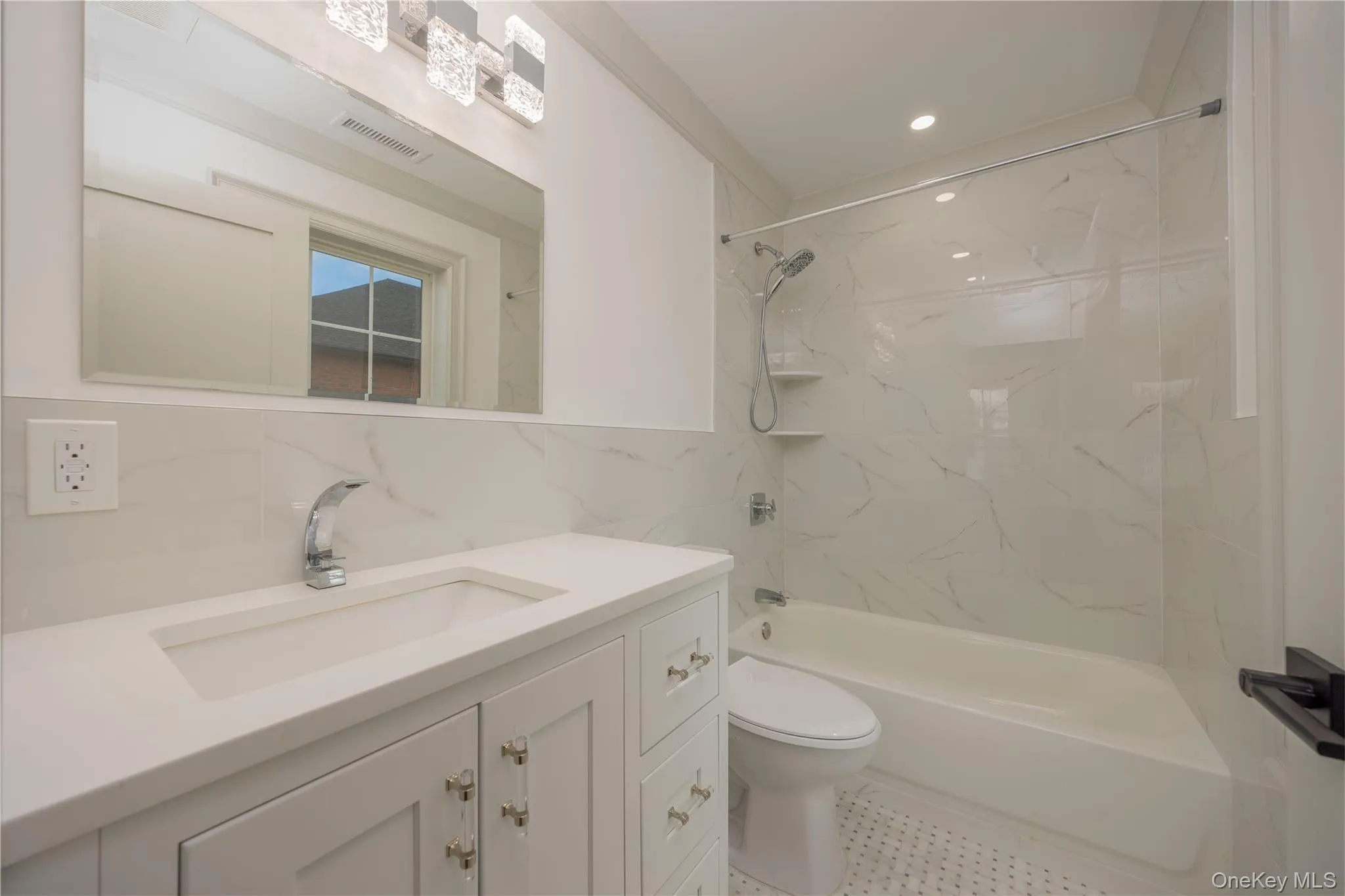 Full bathroom featuring shower / bathtub combination, vanity, decorative backsplash, recessed lighting, and tile walls Full bathroom featuring shower / bathtub combination, vanity, decorative backsplash, recessed lighting, and tile walls