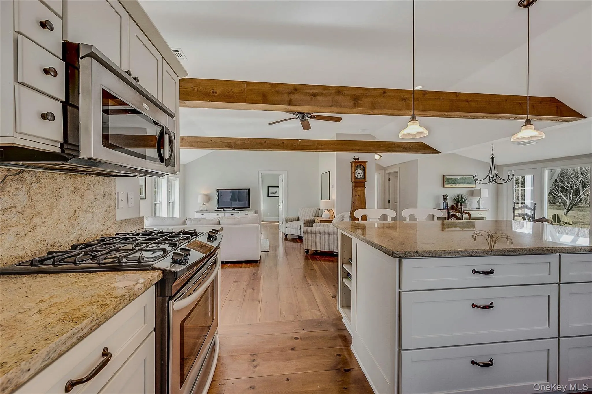 Kitchen featuring appliances with stainless steel finishes, light stone counters, healthy amount of natural light, and pendant lighting Kitchen featuring appliances with stainless steel finishes, light stone counters, healthy amount of natural light, and pendant lighting