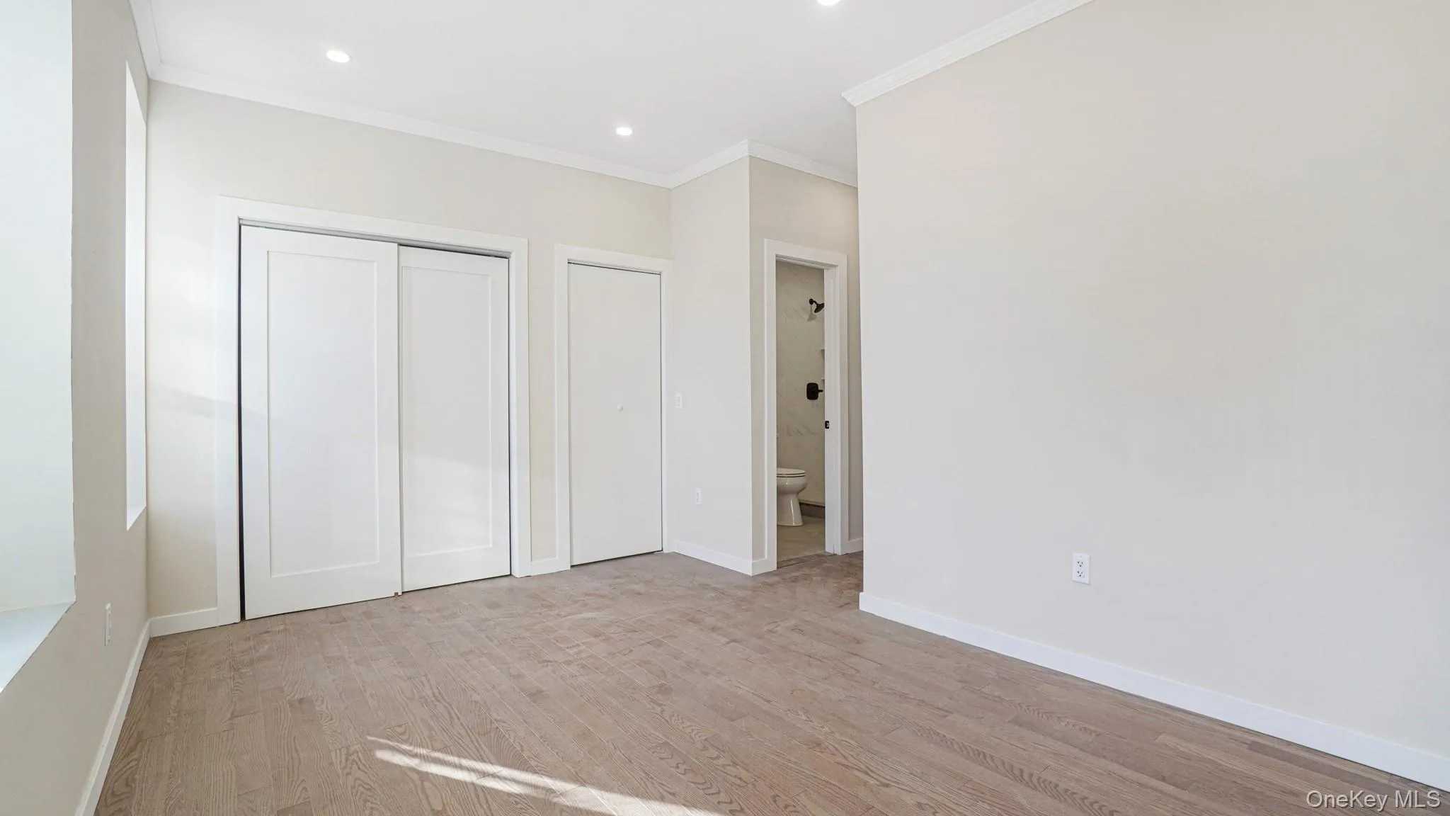 Unfurnished bedroom featuring crown molding, light wood-style floors, a closet, and recessed lighting Unfurnished bedroom featuring crown molding, light wood-style floors, a closet, and recessed lighting
