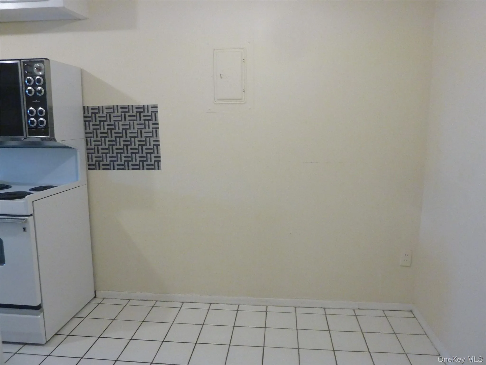 Kitchen featuring electric range and baseboards Kitchen featuring electric range and baseboards