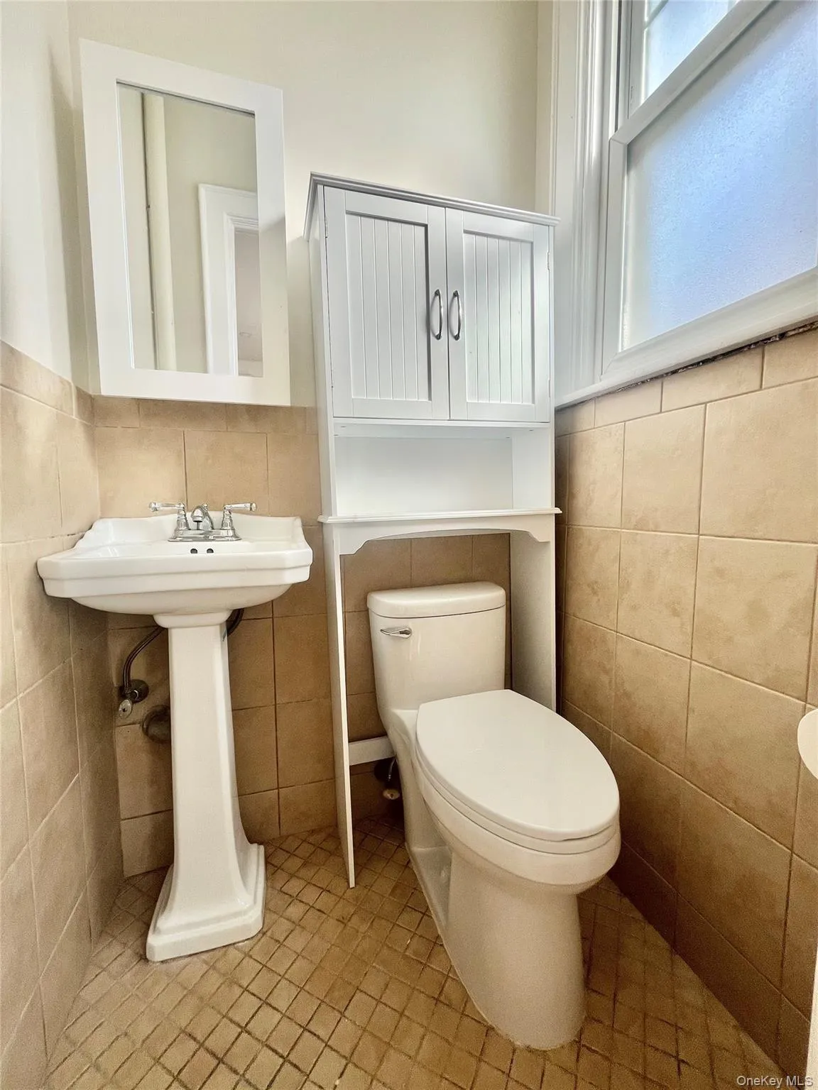 Bathroom featuring tile walls and tile patterned floors Bathroom featuring tile walls and tile patterned floors