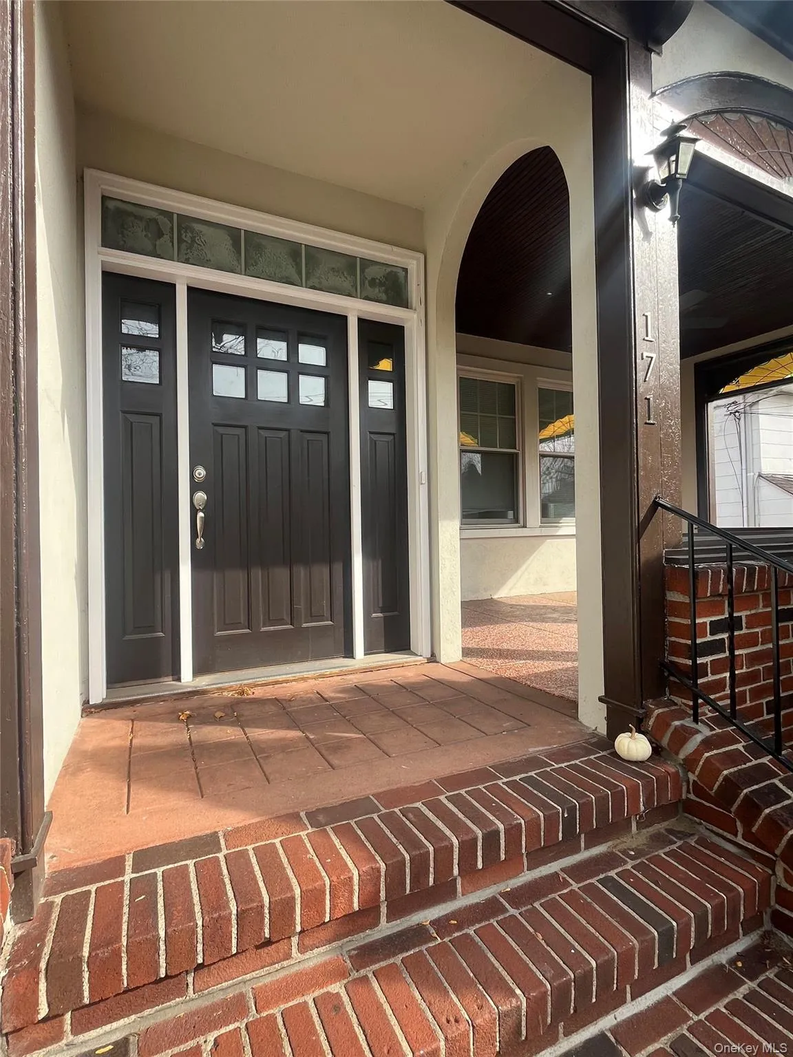 Property entrance featuring a porch and stucco siding Property entrance featuring a porch and stucco siding