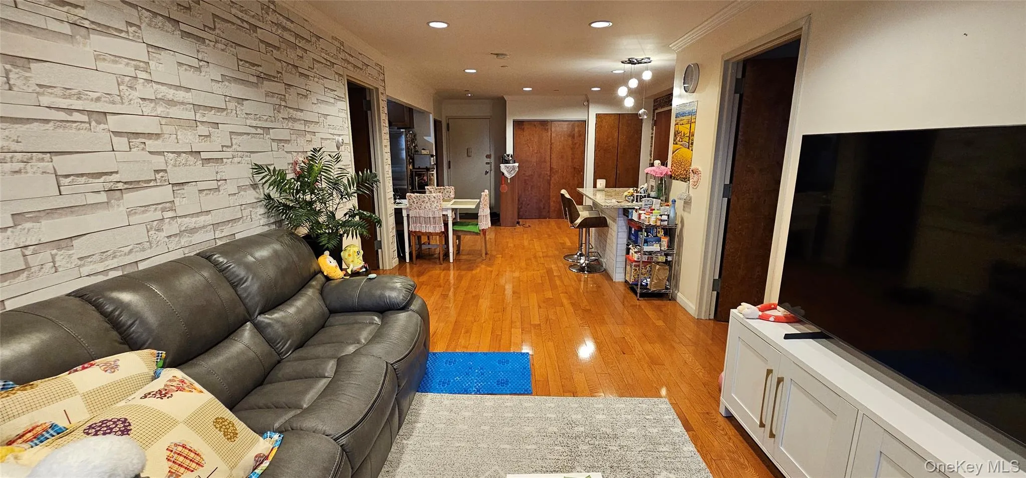 Living area featuring light wood-type flooring and recessed lighting Living area featuring light wood-type flooring and recessed lighting