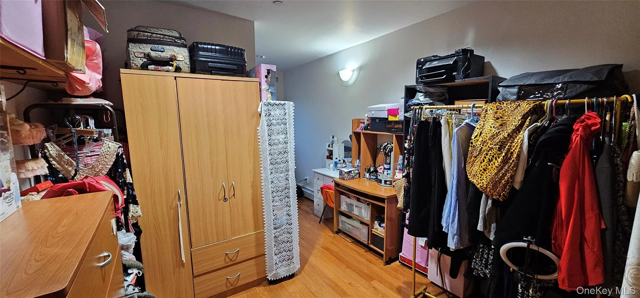 Walk in closet with light wood finished floors Walk in closet with light wood finished floors