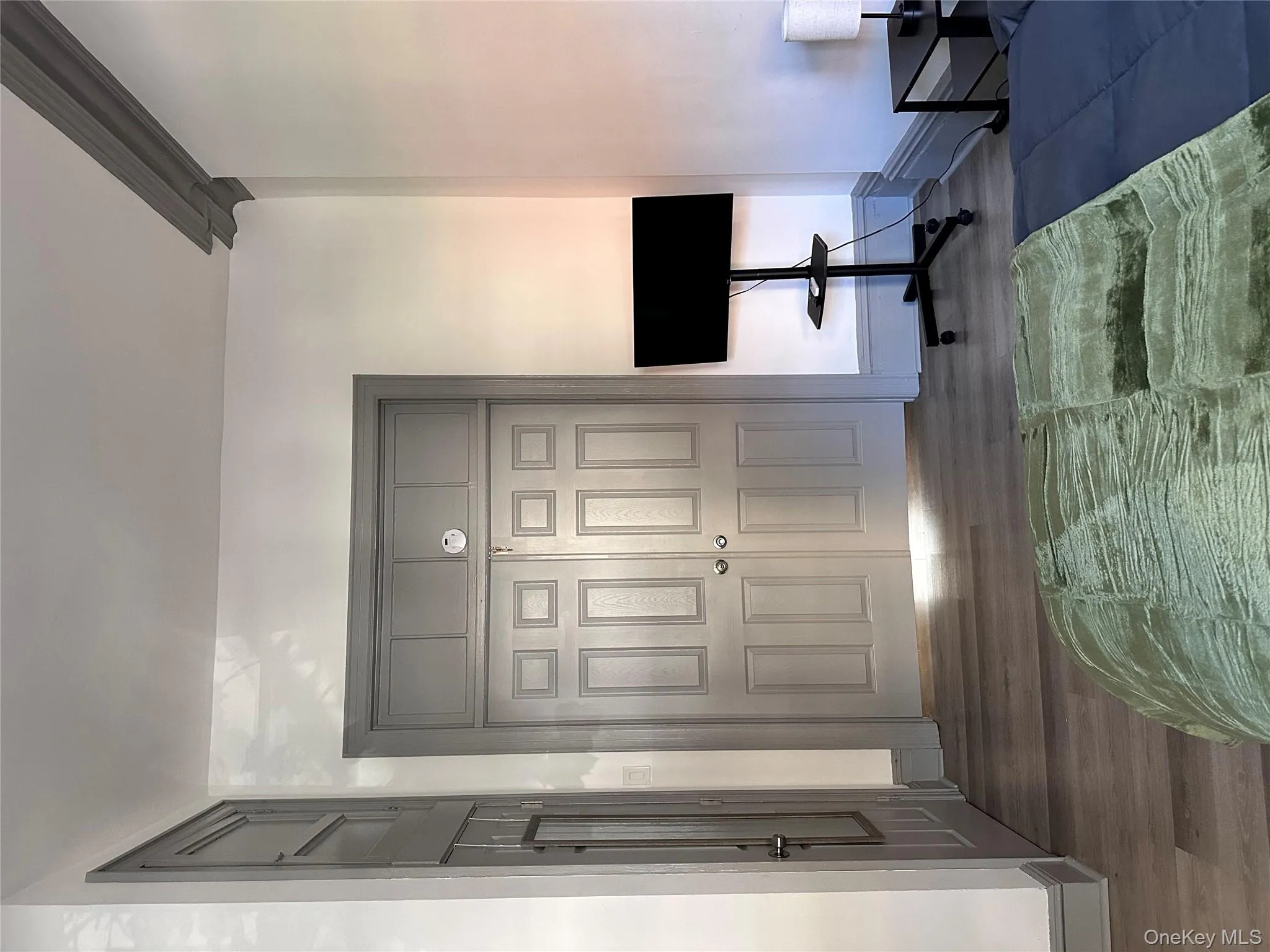 Bedroom featuring wood finished floors and a closet Bedroom featuring wood finished floors and a closet