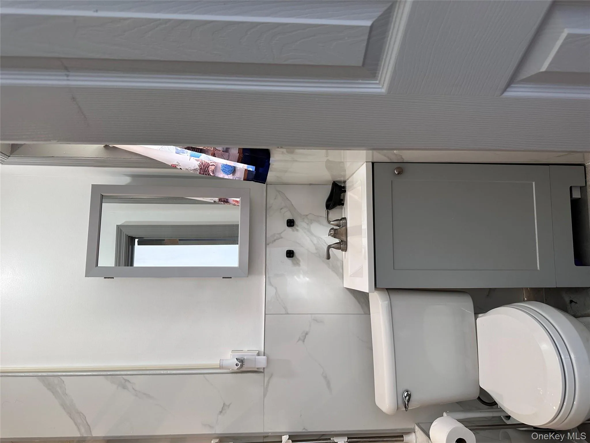 Bathroom featuring vanity and tile walls Bathroom featuring vanity and tile walls