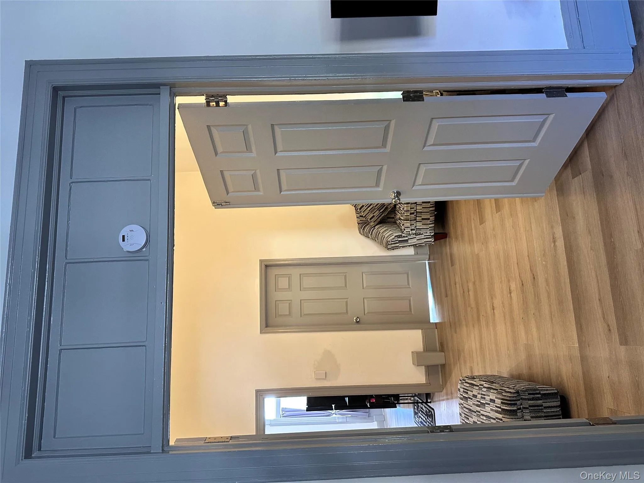 Corridor featuring light wood-type flooring and baseboards Corridor featuring light wood-type flooring and baseboards