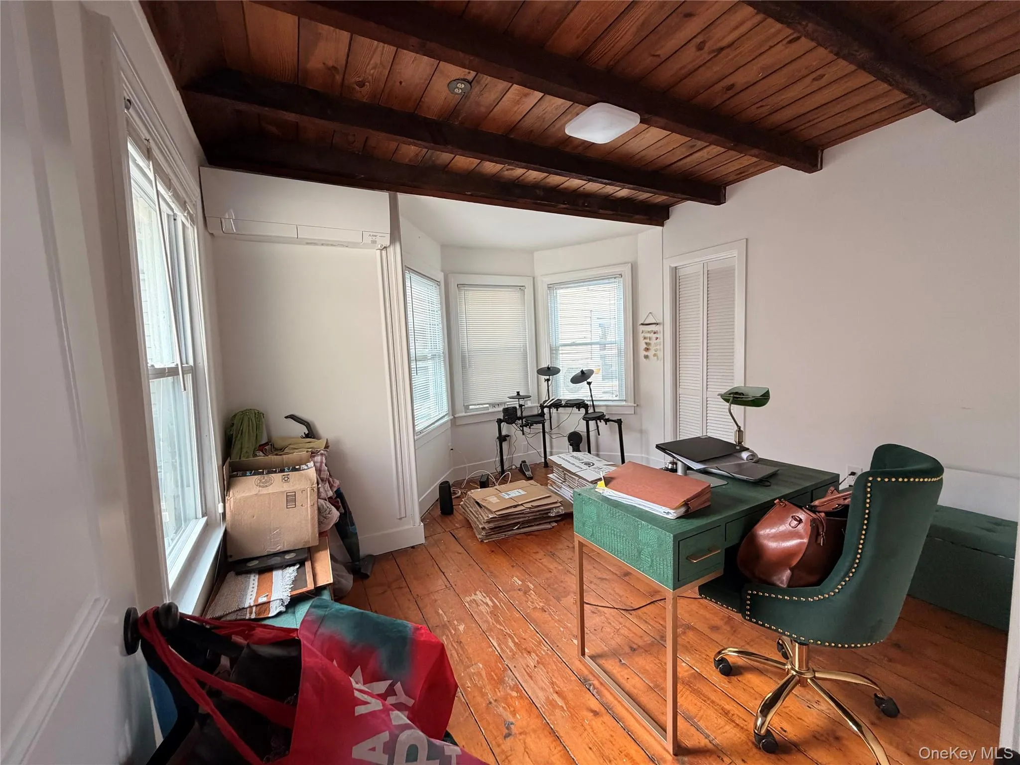 Bedroom 2 featuring hardwood floors, a wood ceiling with exposed beams, and a wall mounted mini split unit Bedroom 2 featuring hardwood floors, a wood ceiling with exposed beams, and a wall mounted mini split unit