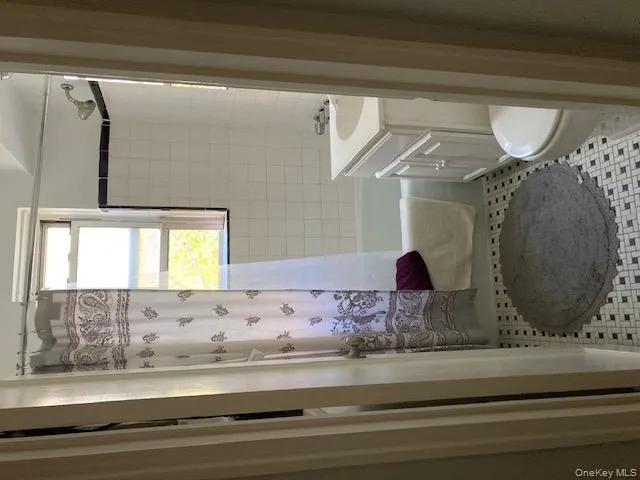 Full bath with vanity, shower / bath combo with shower curtain, and light tile patterned floors Full bath with vanity, shower / bath combo with shower curtain, and light tile patterned floors