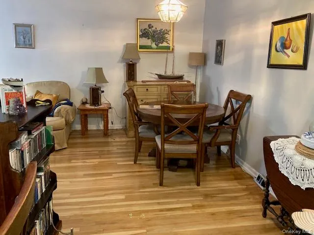 Living area with light wood-style floors and baseboards Living area with light wood-style floors and baseboards