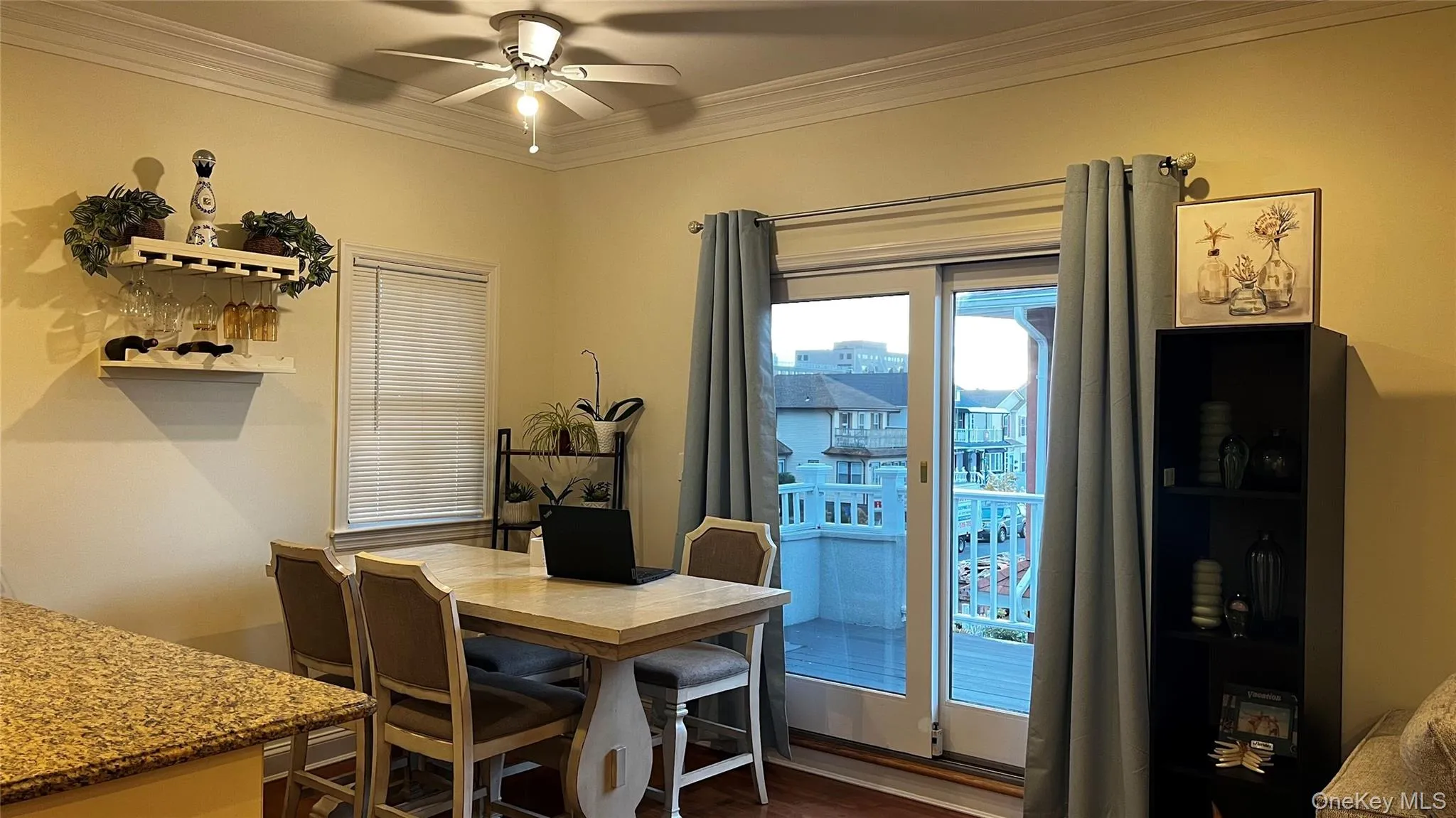 Dining area featuring crown molding, dark wood finished floors, and a ceiling fan Dining area featuring crown molding, dark wood finished floors, and a ceiling fan