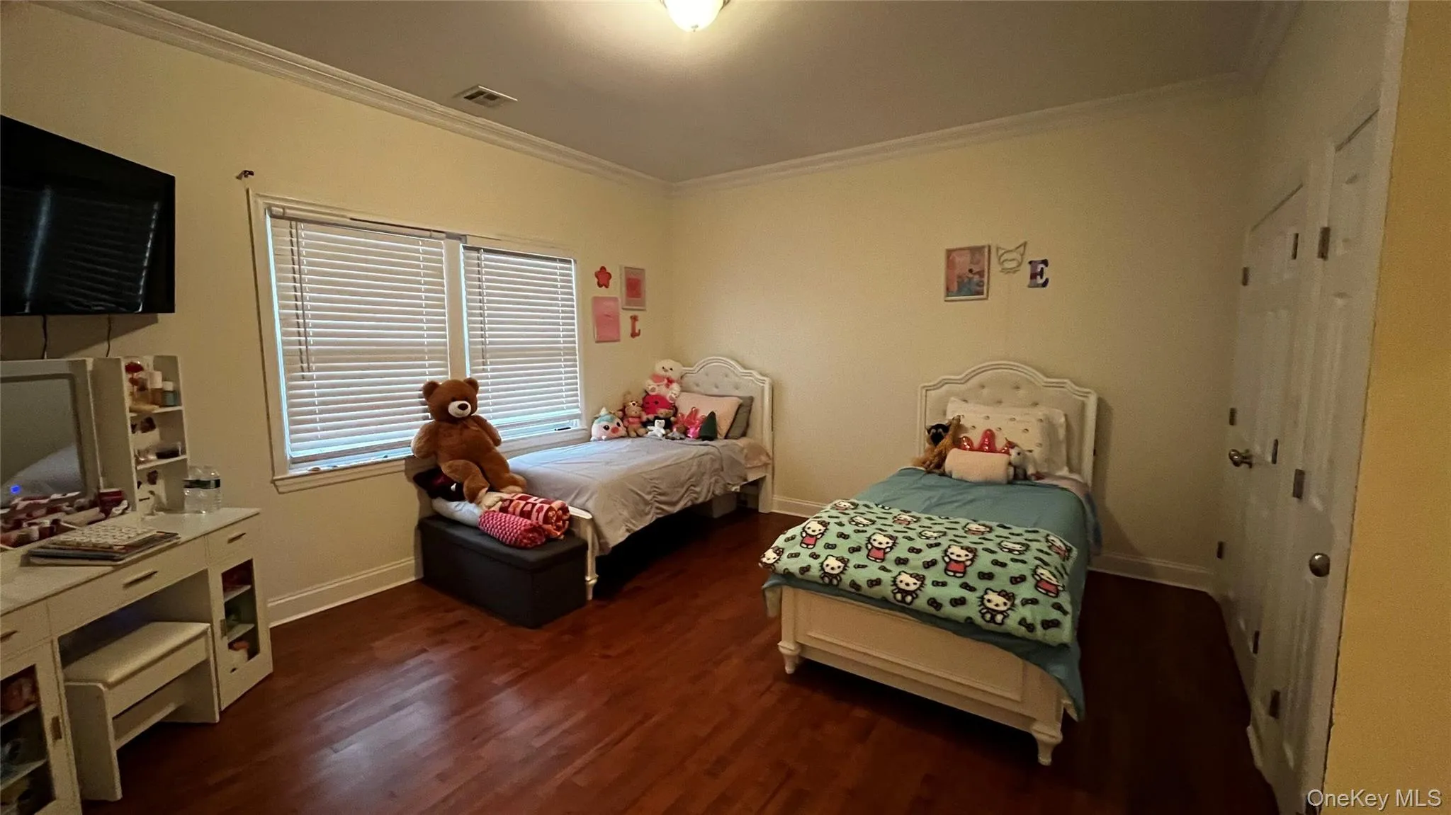 Bedroom with crown molding, dark wood finished floors, and a closet Bedroom with crown molding, dark wood finished floors, and a closet