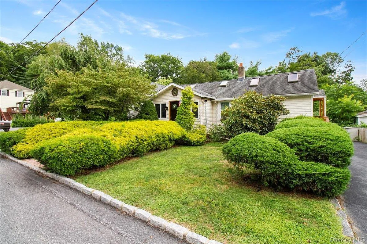 View of front of home with a chimney and a front lawn View of front of home with a chimney and a front lawn