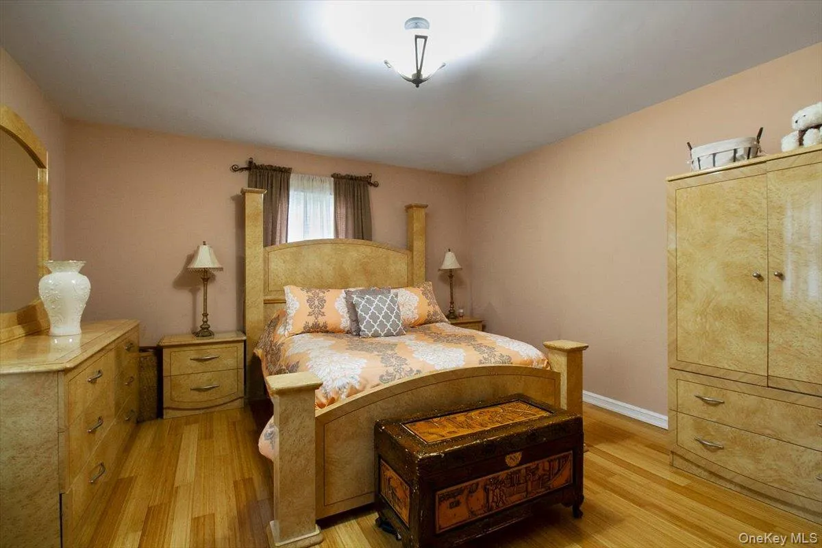 Bedroom with light wood-type flooring and baseboards Bedroom with light wood-type flooring and baseboards