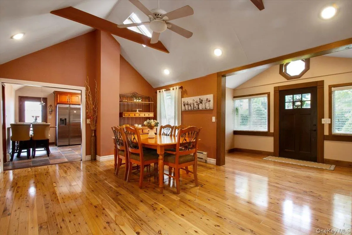Dining space featuring light wood-style flooring, high vaulted ceiling, recessed lighting, beam ceiling, and ceiling fan Dining space featuring light wood-style flooring, high vaulted ceiling, recessed lighting, beam ceiling, and ceiling fan