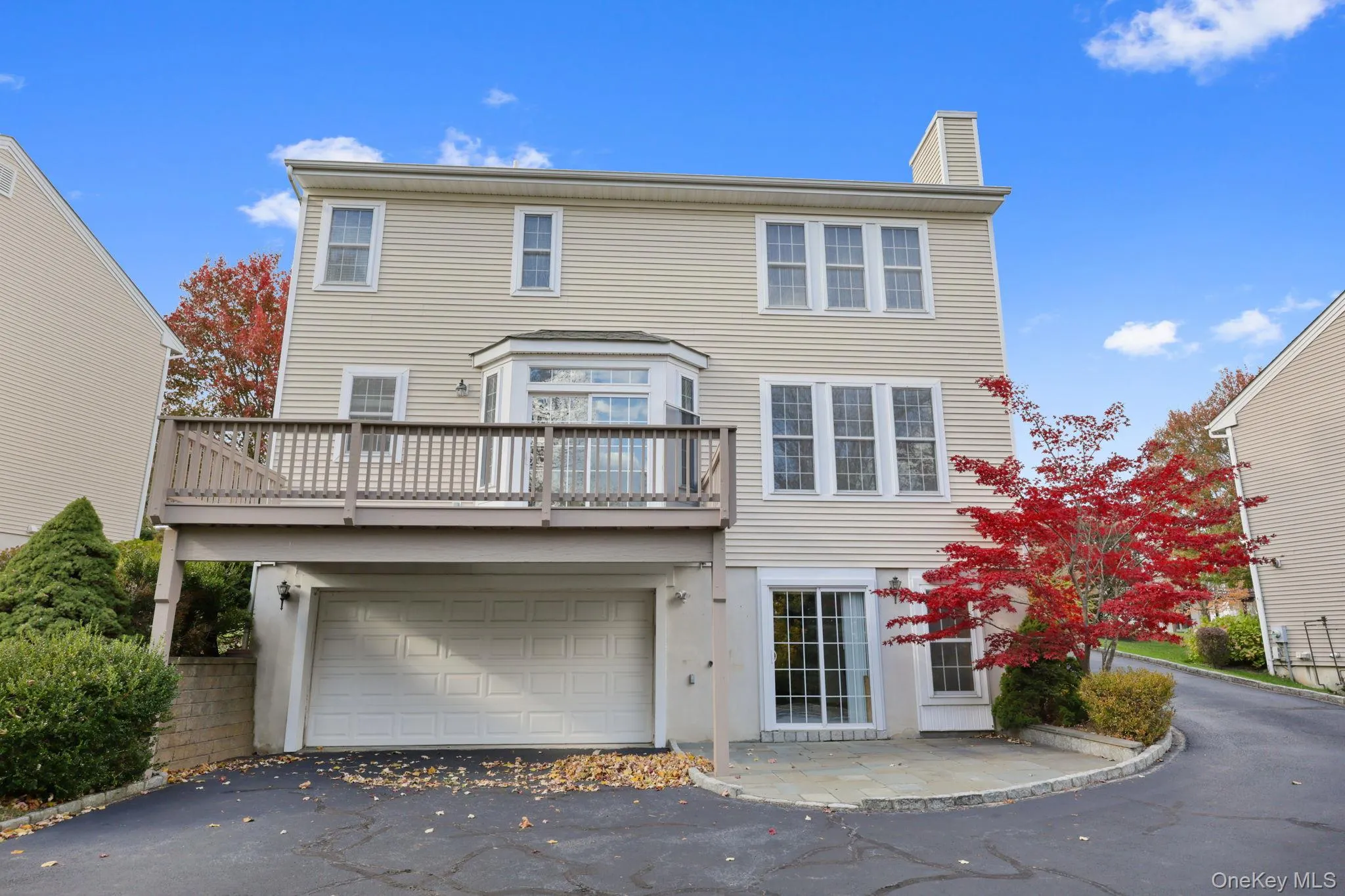 View of front of house with asphalt driveway, an attached garage, and a chimney View of front of house with asphalt driveway, an attached garage, and a chimney