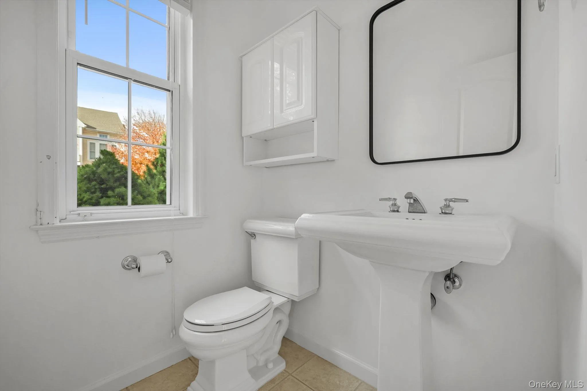 Half bathroom with light tile patterned flooring and baseboards Half bathroom with light tile patterned flooring and baseboards