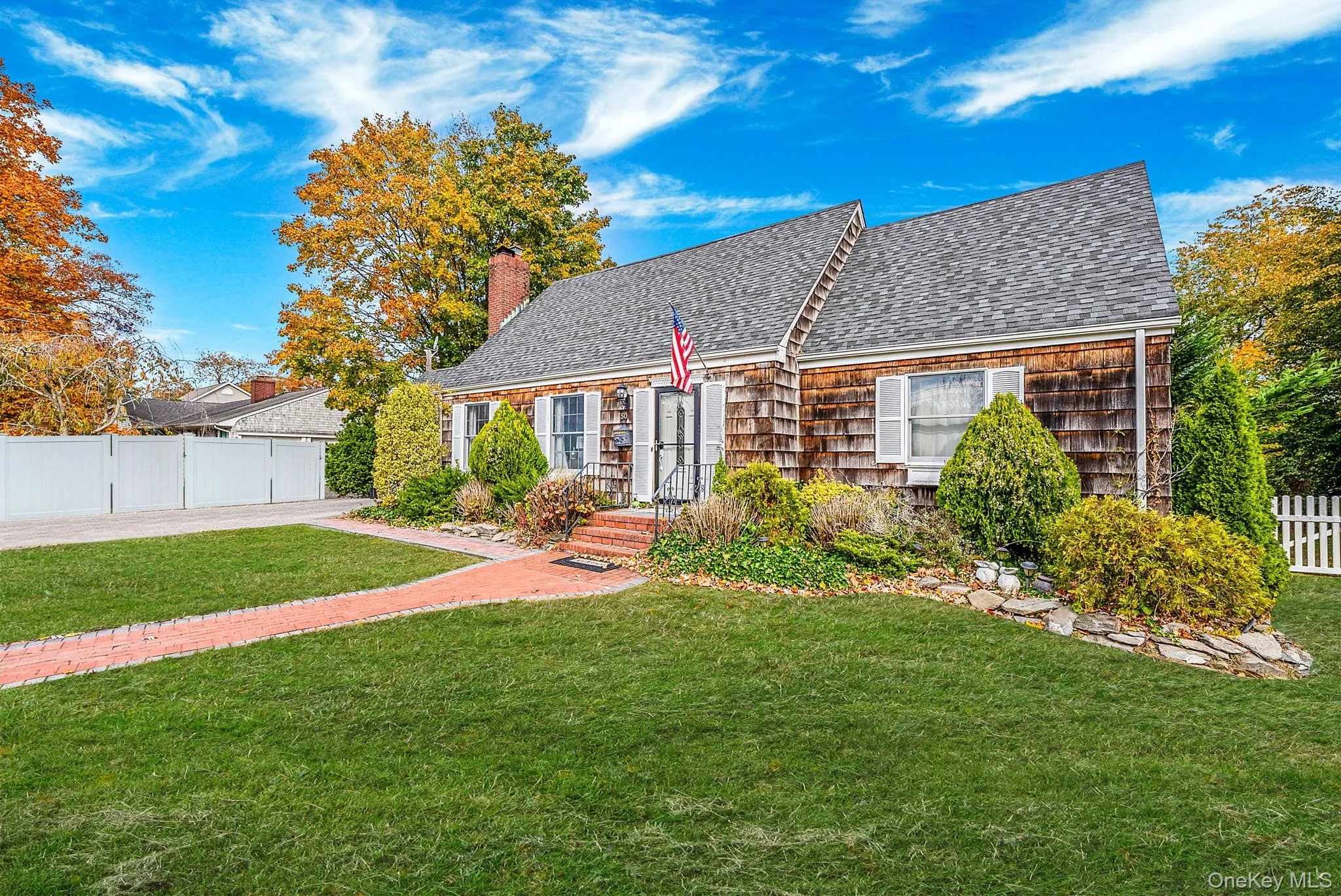 View of front of property with roof with shingles and a chimney View of front of property with roof with shingles and a chimney