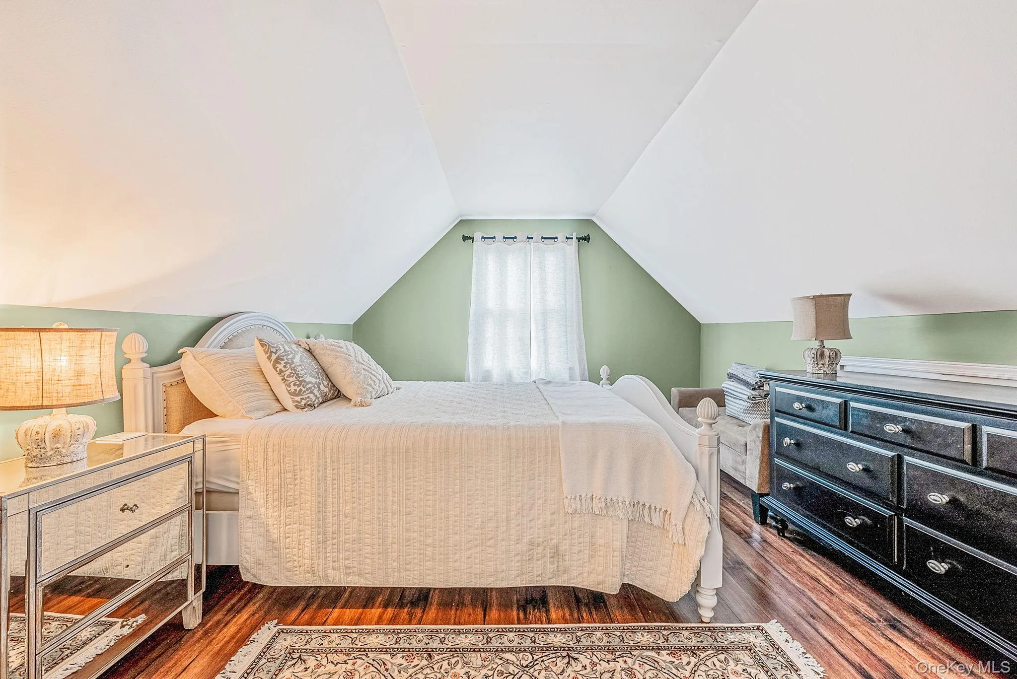Bedroom with vaulted ceiling and dark wood-style flooring Bedroom with vaulted ceiling and dark wood-style flooring