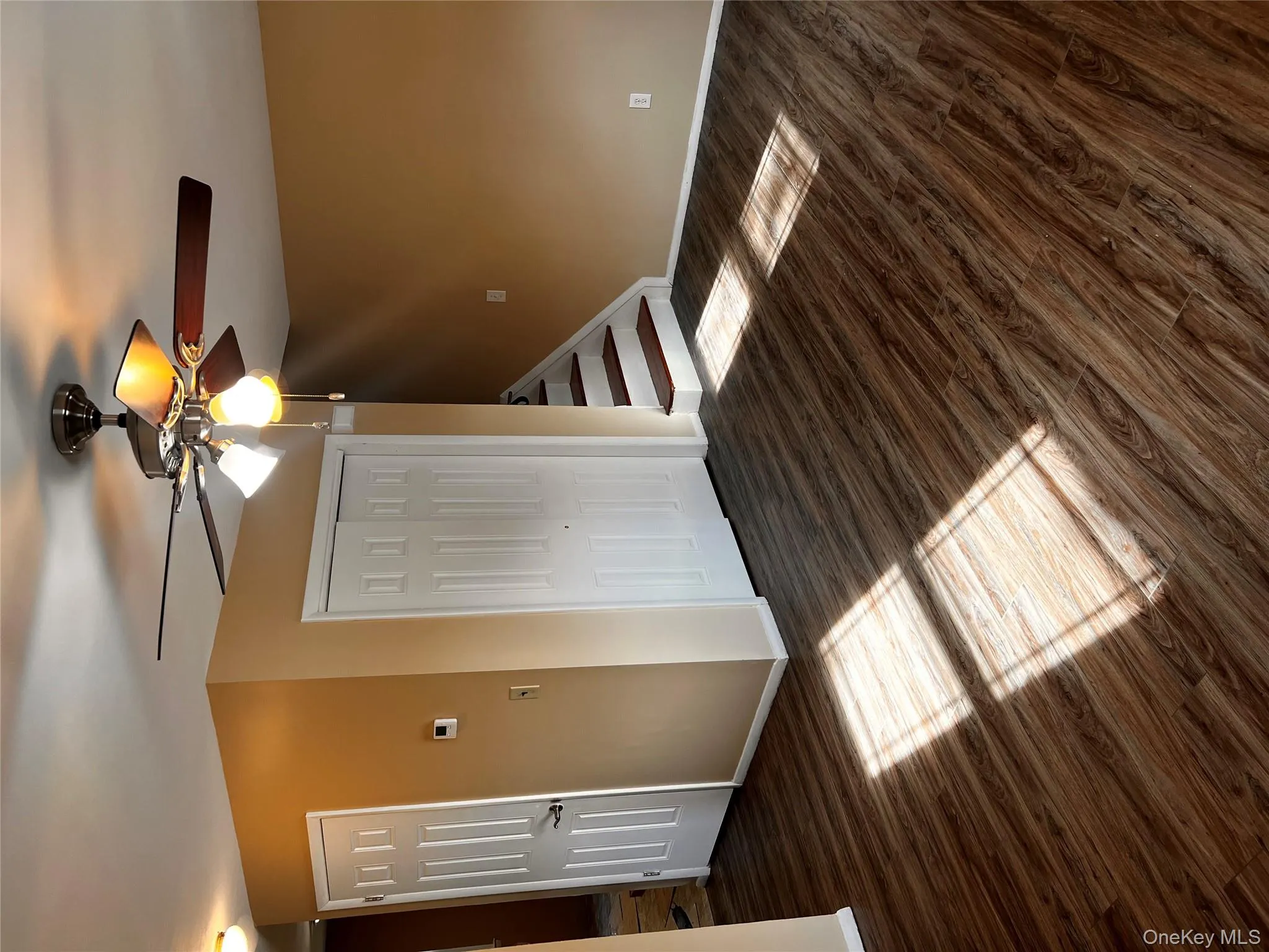 Unfurnished bedroom with dark wood-type flooring, ceiling fan, and a closet Unfurnished bedroom with dark wood-type flooring, ceiling fan, and a closet