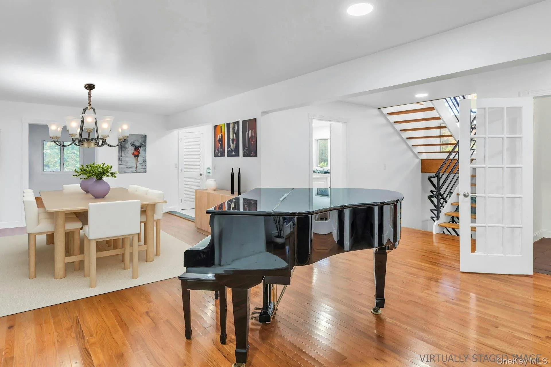 Dining space with light wood-style floors, stairs, a chandelier, recessed lighting, and healthy amount of natural light Dining space with light wood-style floors, stairs, a chandelier, recessed lighting, and healthy amount of natural light
