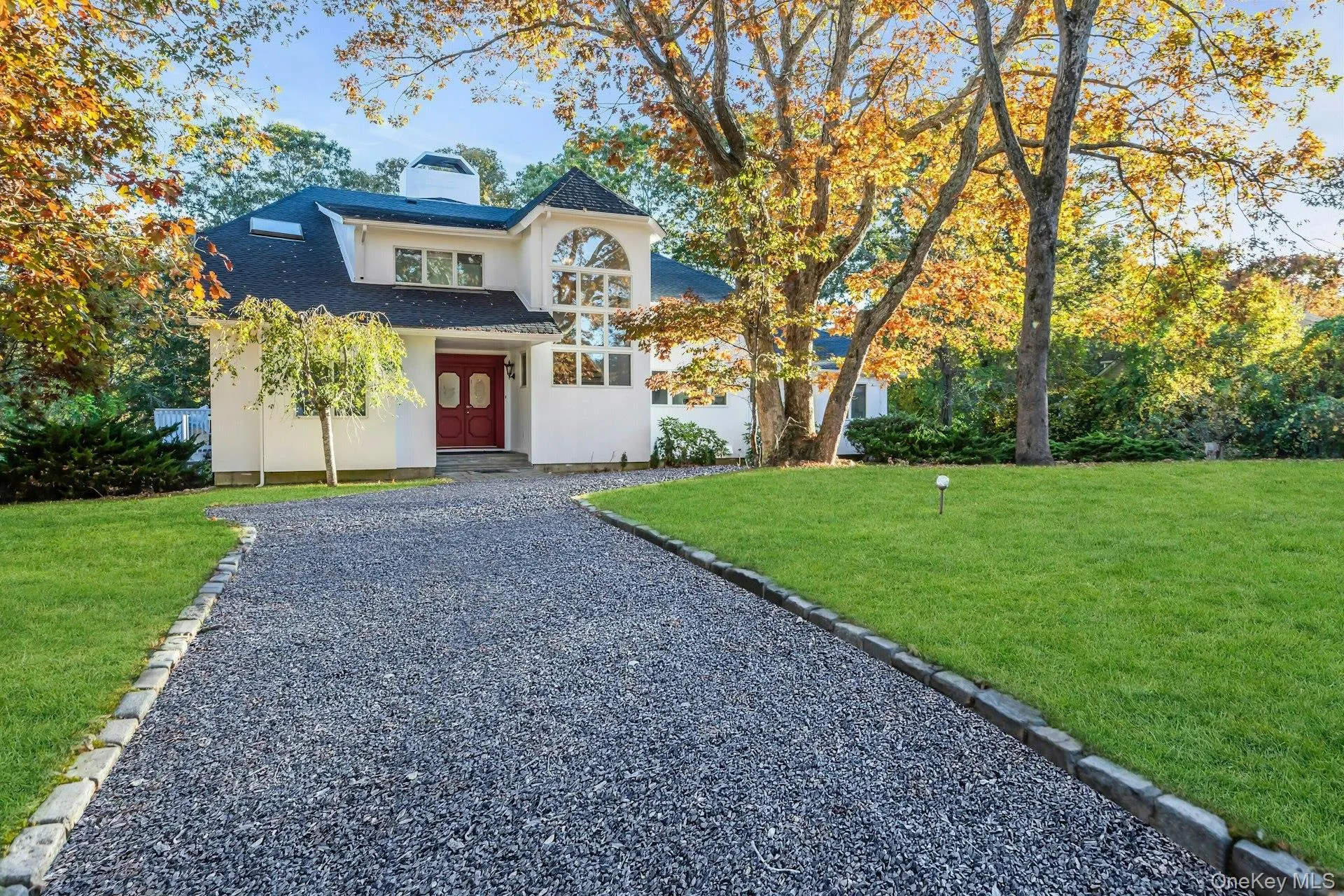 View of front of home featuring a front lawn, stucco siding, a chimney, and a shingled roof View of front of home featuring a front lawn, stucco siding, a chimney, and a shingled roof