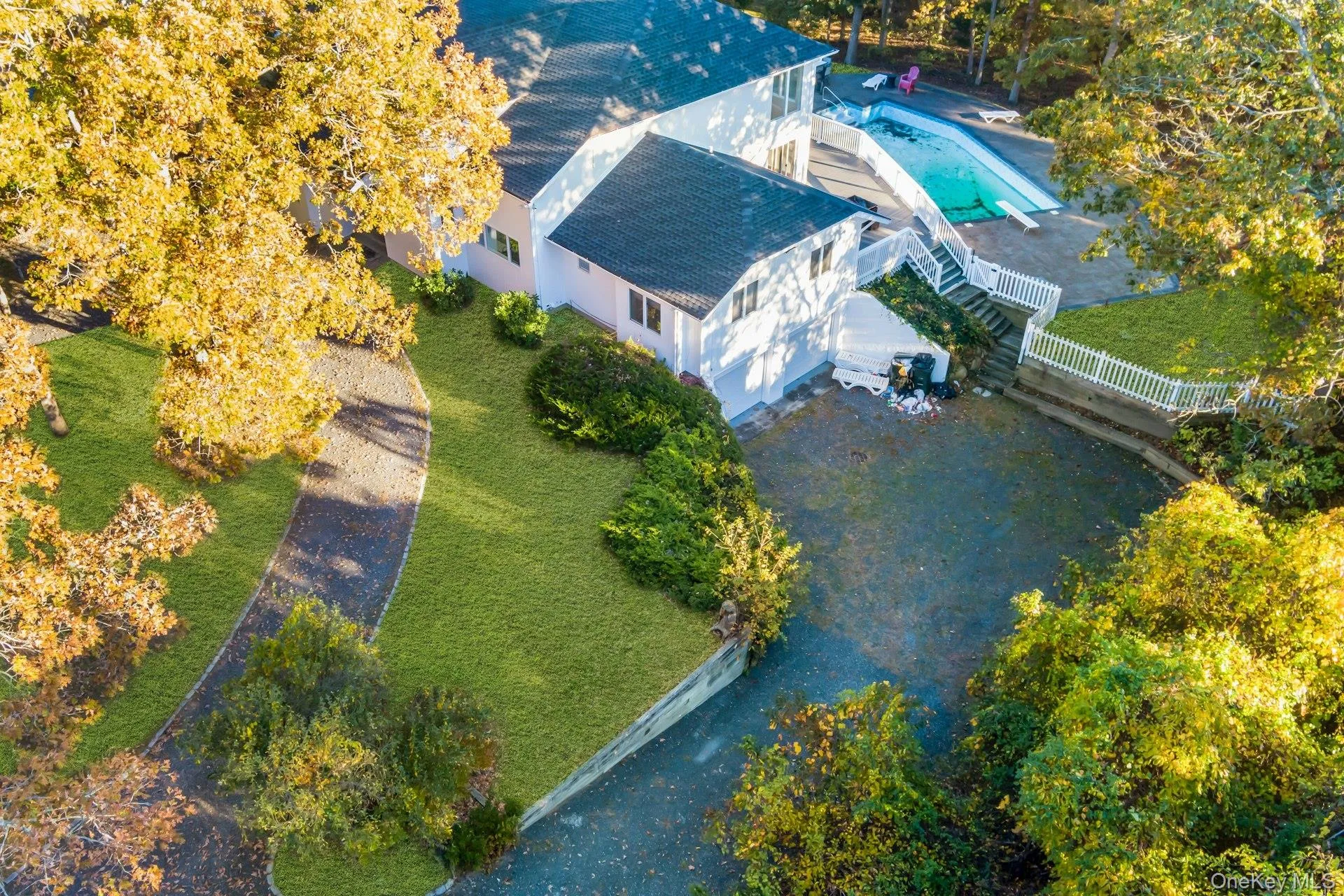 Aerial view of property and surrounding area with a pool Aerial view of property and surrounding area with a pool
