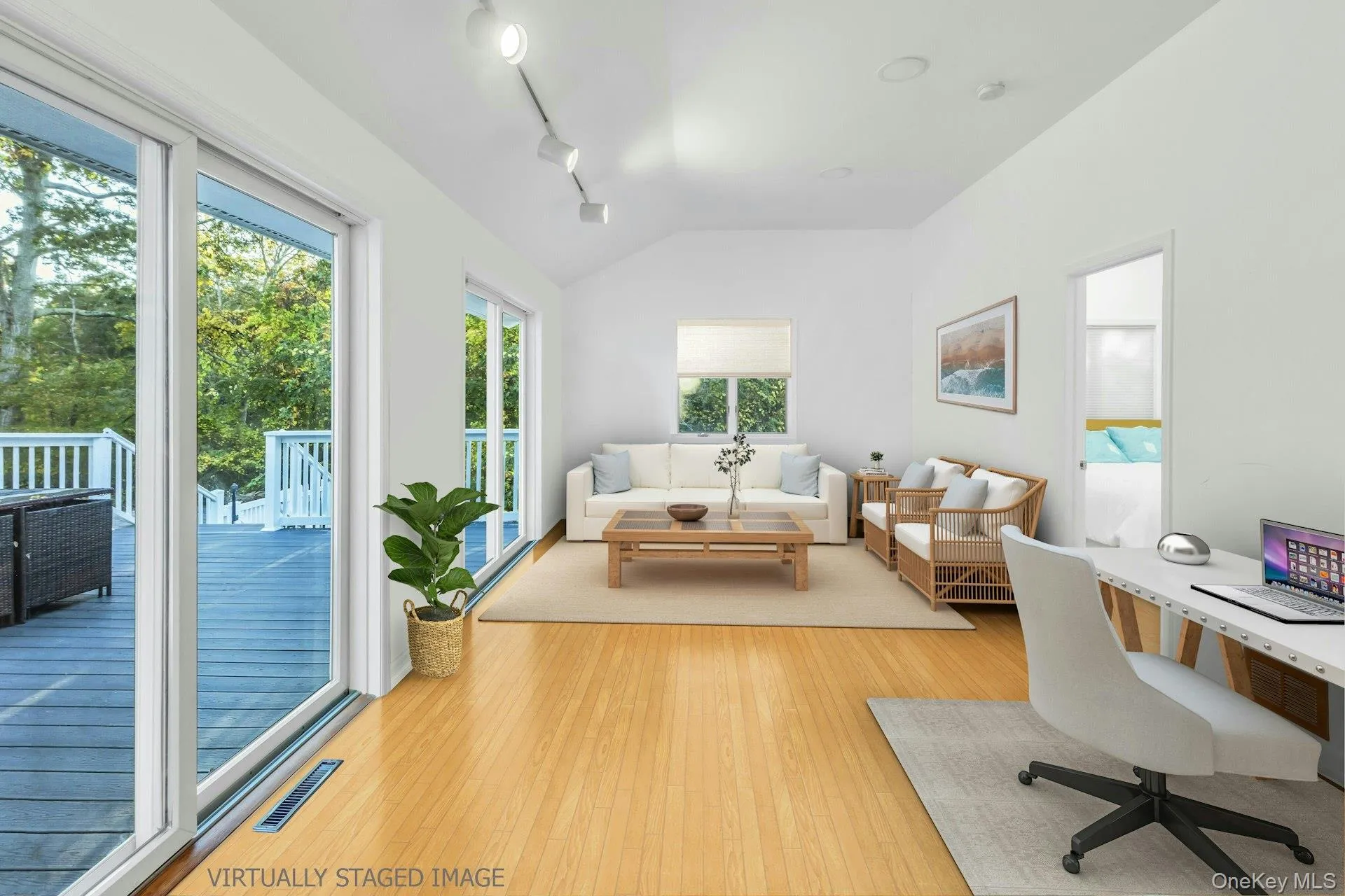 Office space with light wood finished floors, track lighting, and vaulted ceiling Office space with light wood finished floors, track lighting, and vaulted ceiling