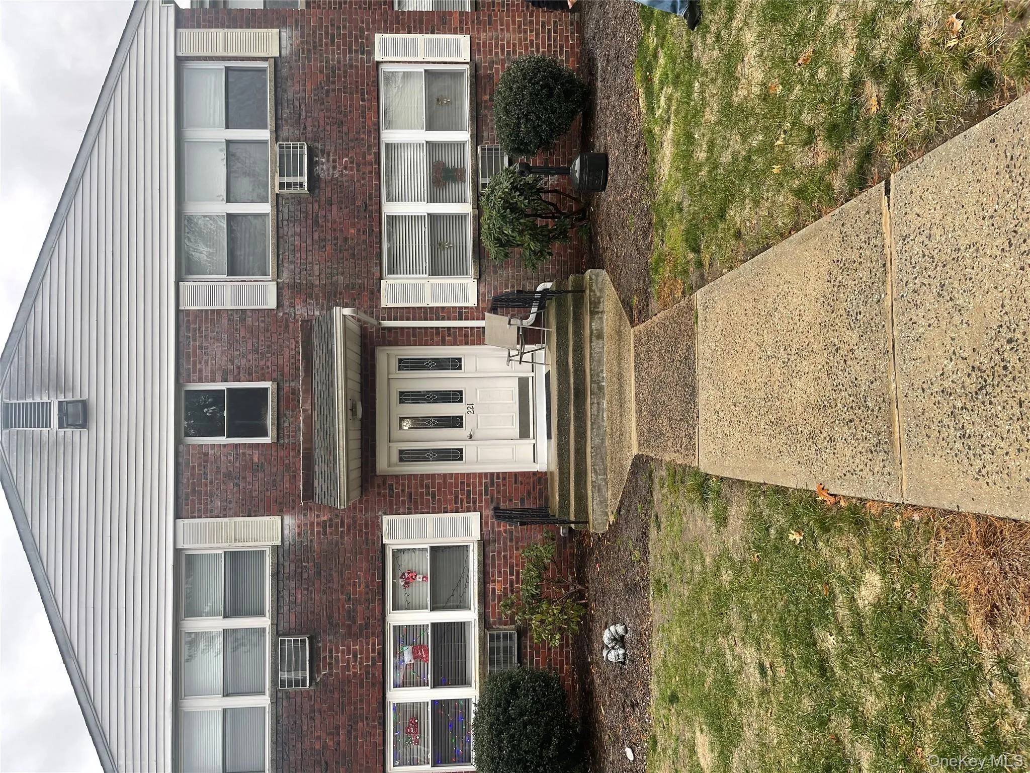 View of front of property with brick siding and a front yard View of front of property with brick siding and a front yard
