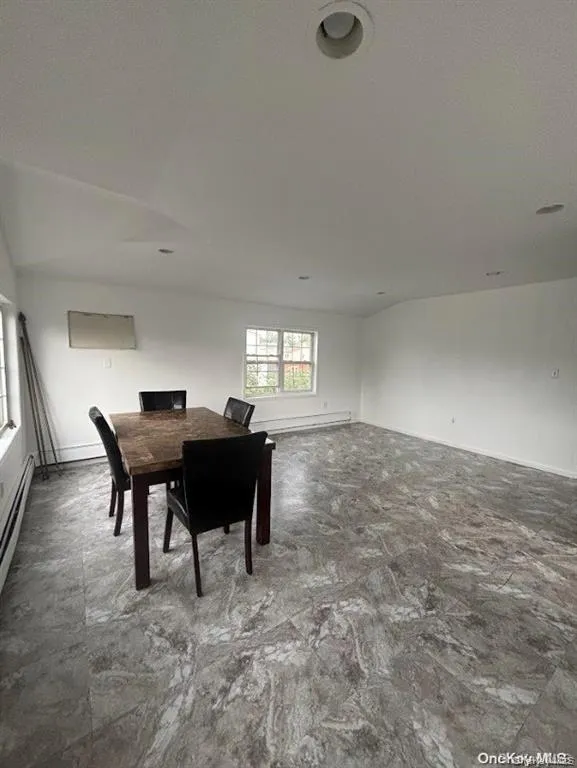 Dining room with a baseboard radiator and a baseboard heating unit Dining room with a baseboard radiator and a baseboard heating unit