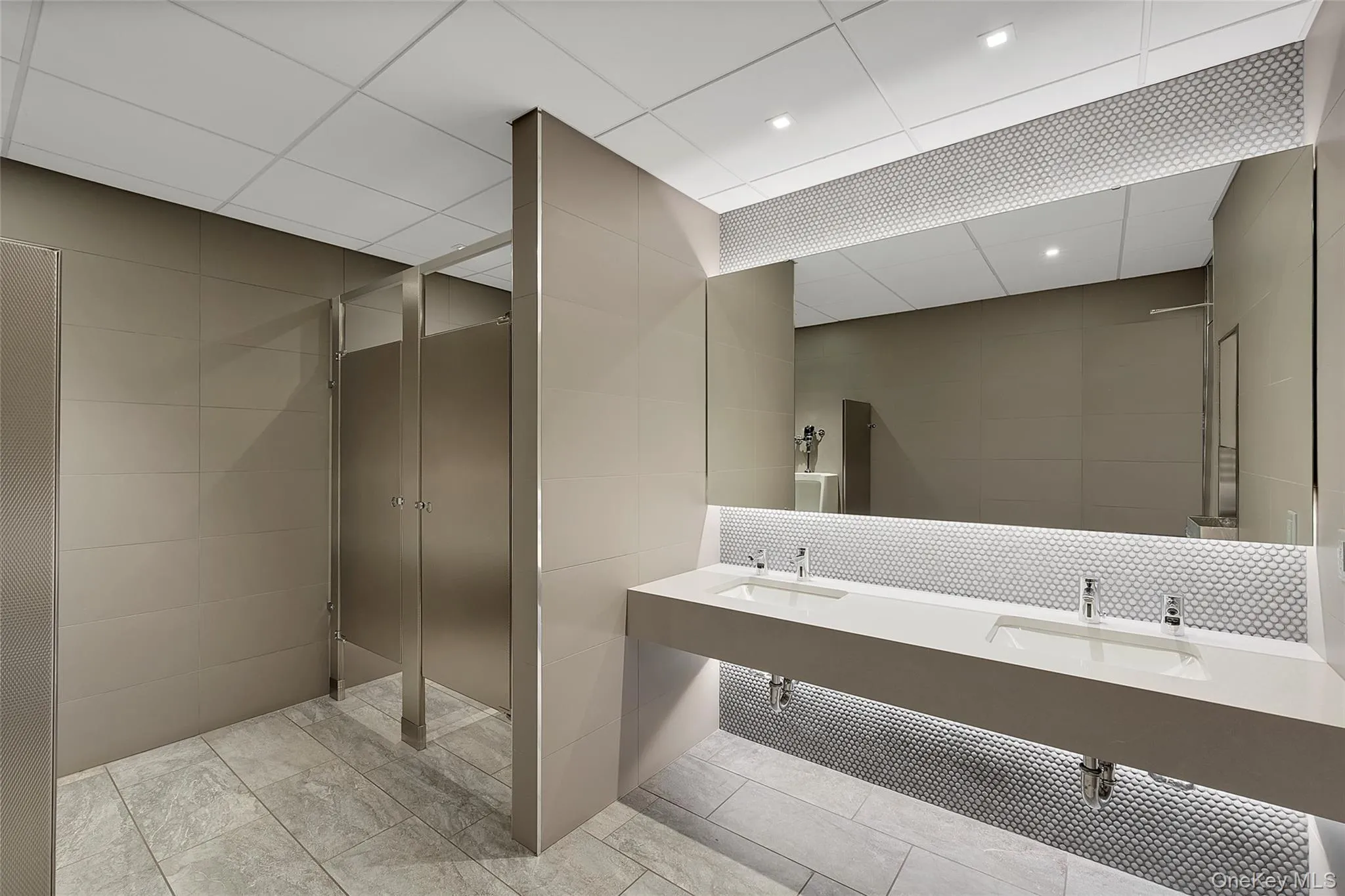 Bathroom featuring tile walls and double vanity Bathroom featuring tile walls and double vanity