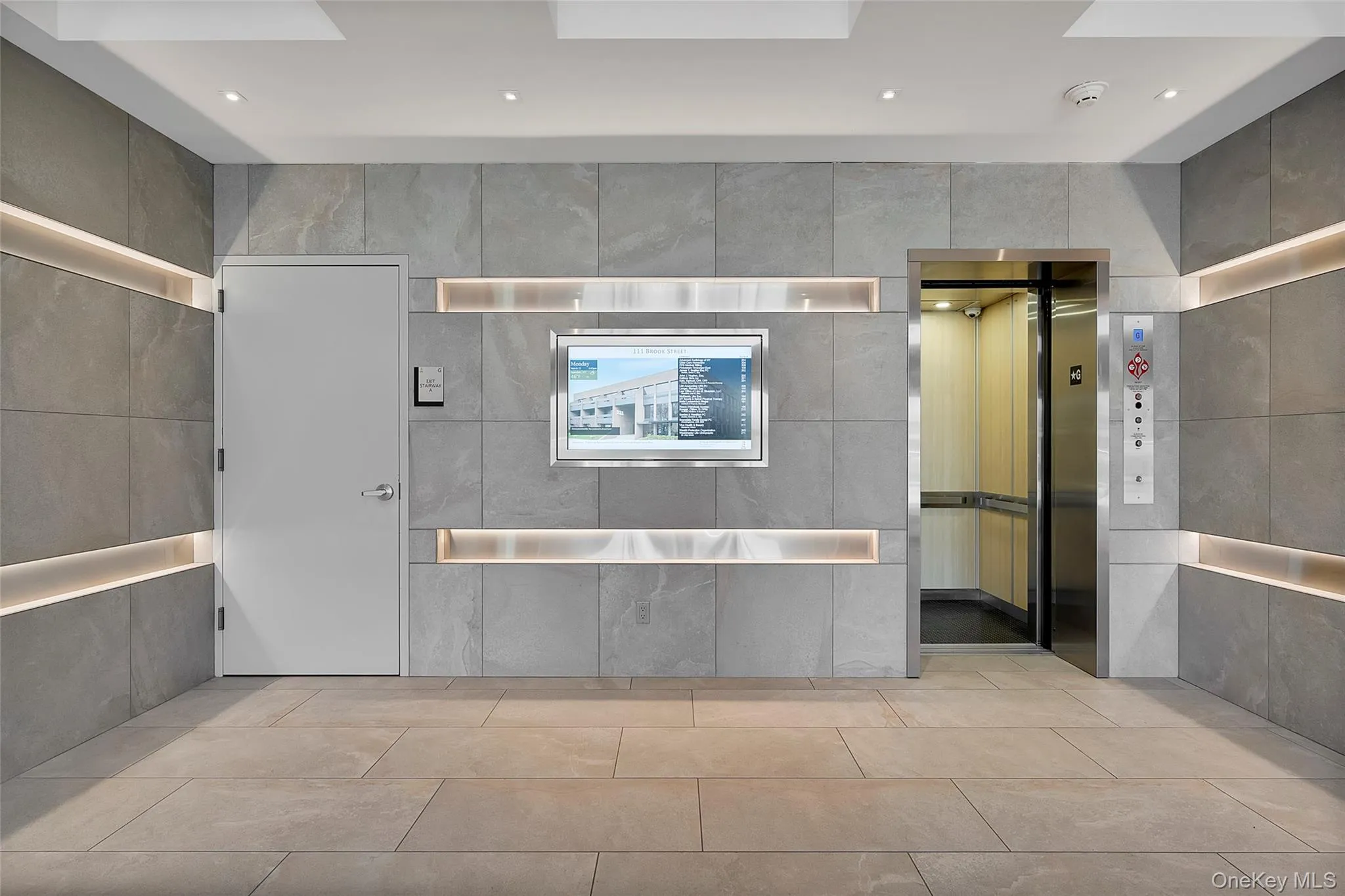 Full bath with tile walls, elevator, and recessed lighting Full bath with tile walls, elevator, and recessed lighting