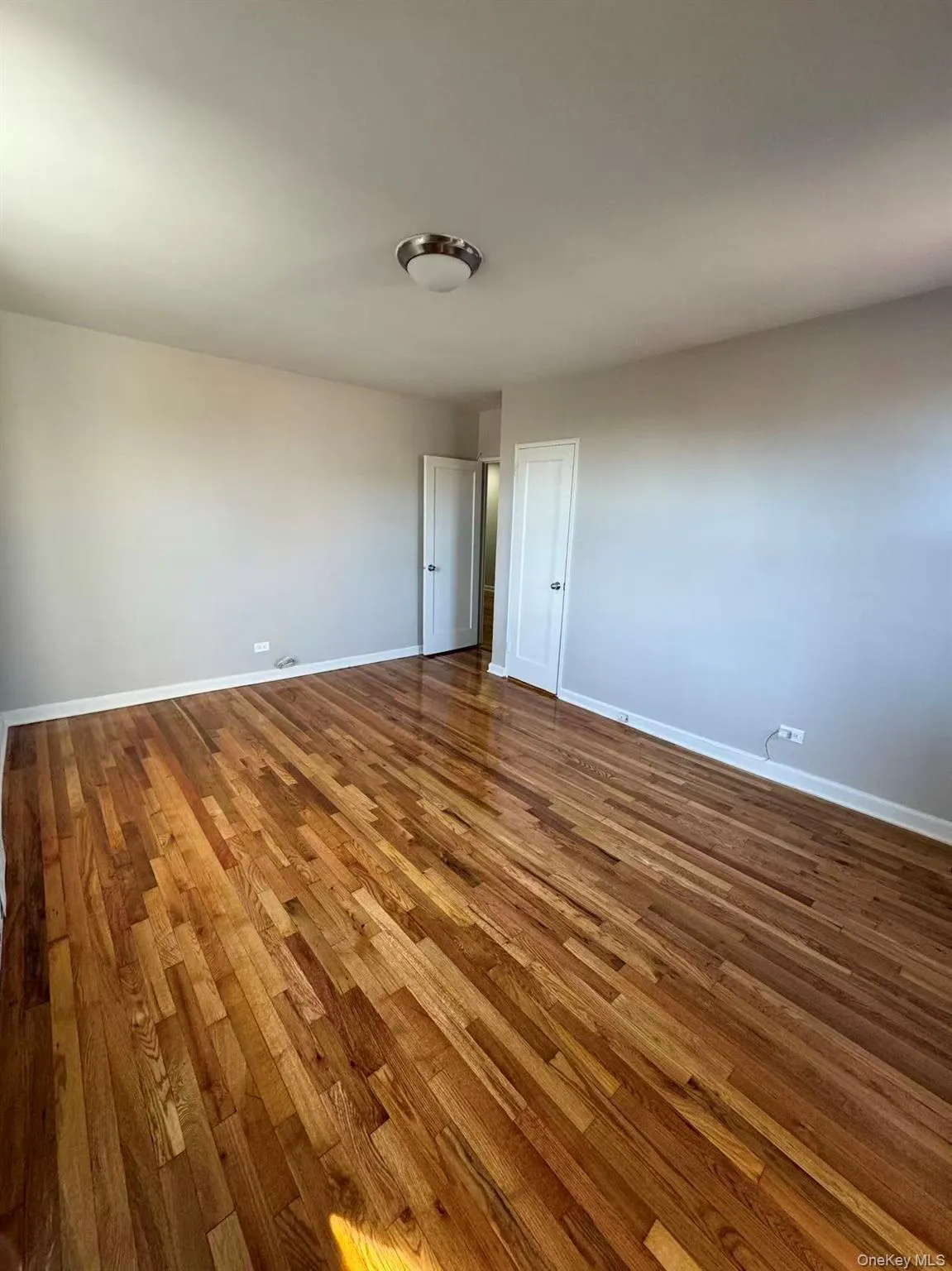 Empty room featuring dark wood-style floors Empty room featuring dark wood-style floors
