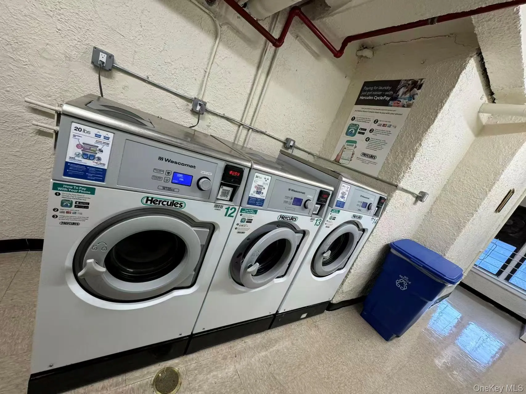 Shared laundry room with a textured wall and washing machine and dryer Shared laundry room with a textured wall and washing machine and dryer