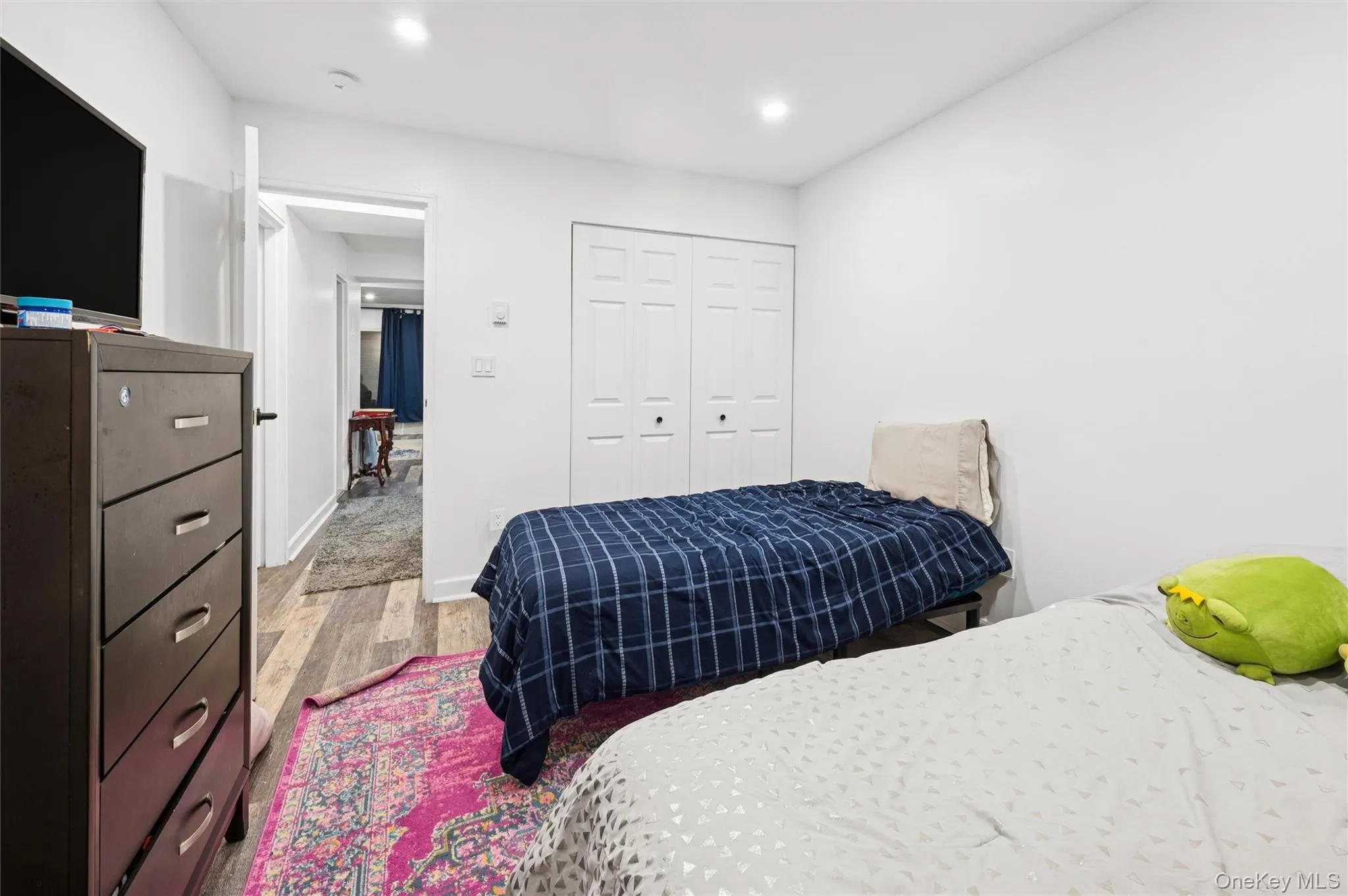 Bedroom with light wood-style flooring, a closet, and recessed lighting Bedroom with light wood-style flooring, a closet, and recessed lighting