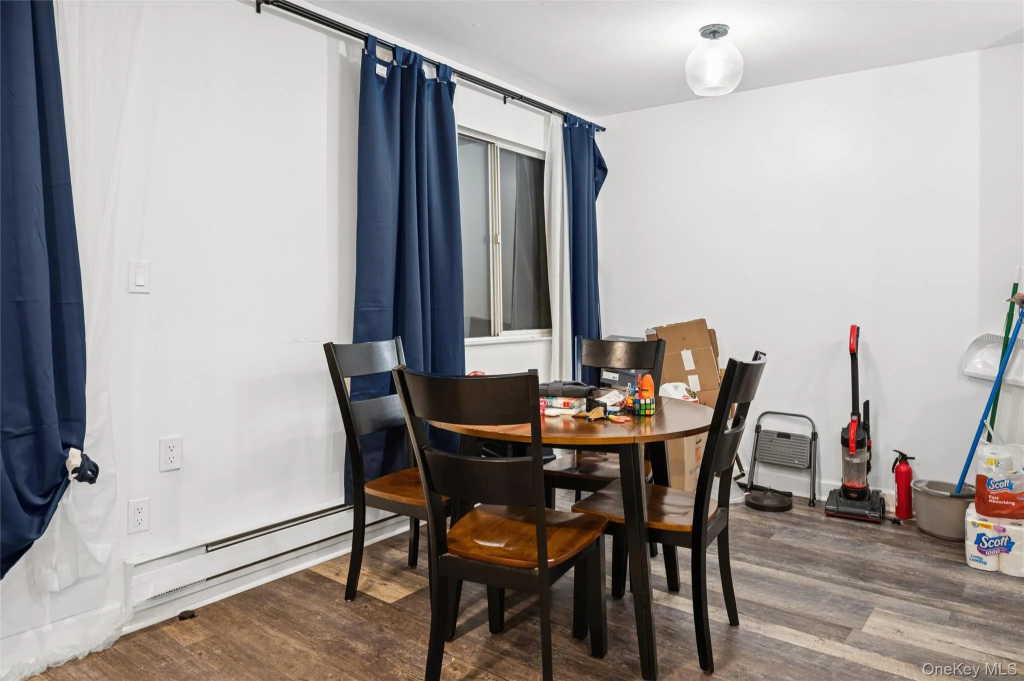 Dining space featuring dark wood-style flooring Dining space featuring dark wood-style flooring