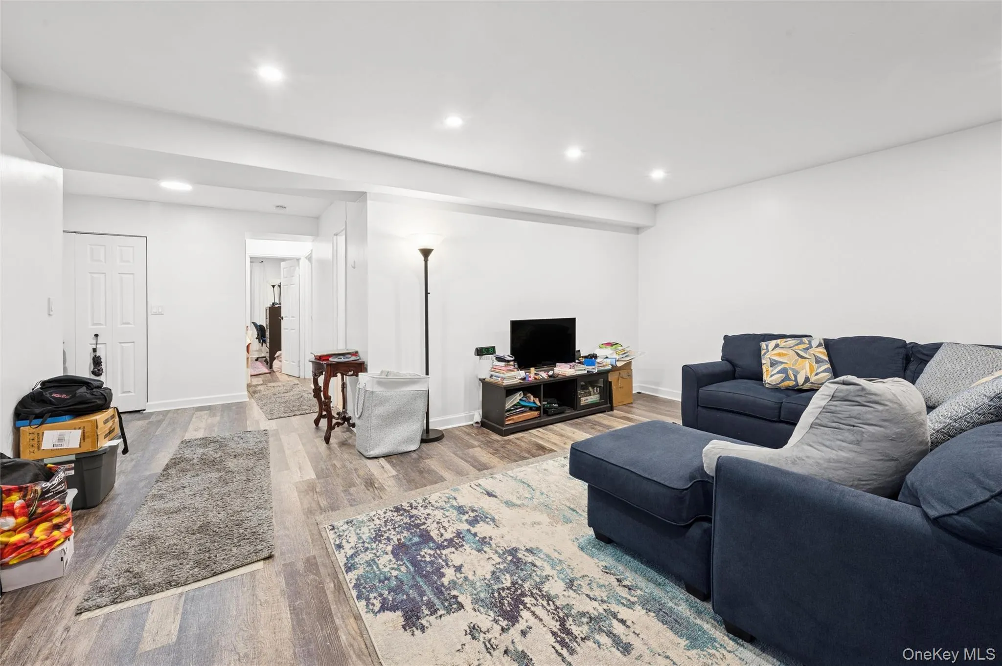 Living room featuring wood finished floors and recessed lighting Living room featuring wood finished floors and recessed lighting