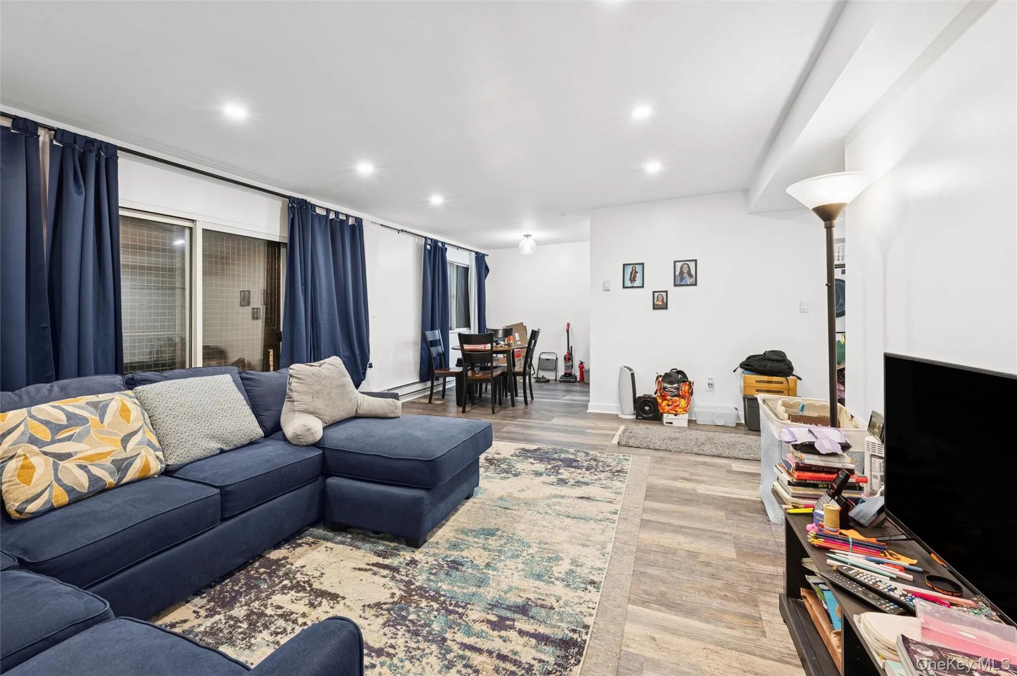 Living area with light wood-type flooring and recessed lighting Living area with light wood-type flooring and recessed lighting