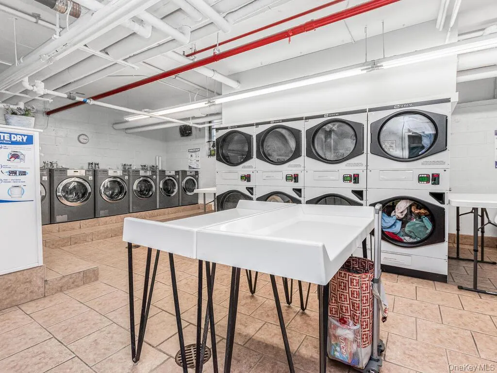 Shared laundry with separate washer and dryer and stacked washer and clothes dryer Shared laundry with separate washer and dryer and stacked washer and clothes dryer